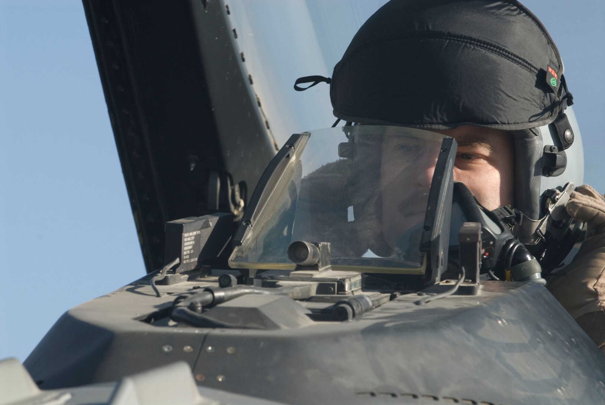 Capt. Travis Keenan dons his helmet in preparation for a combat mission Dec. 17 at Balad Air Base, Iraq. Captain Keenan, a 22nd Expeditionary Fighter Squadron fighter pilot, is deployed from Spangdahlem Air Base, Germany. (U.S. Air Force photo/Staff Sgt. Joshua Garcia)
