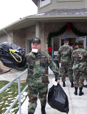 Senior Master Sgt. David Warner, first sergeant for the 419th Maintenance Operations Flight, hauls bags full of Christmas gifts from the Utah Foster Care Foundation's Christmas Box house in Ogden Monday.  Sergeant Warner joined about 50 Airmen from the 419th and 388th Fighter Wings who delivered the gifts to foster homes across Northern Utah.  The gifts were donated by local businesses, churches and citizens.(U.S. Air Force Photo/Kari Tilton)