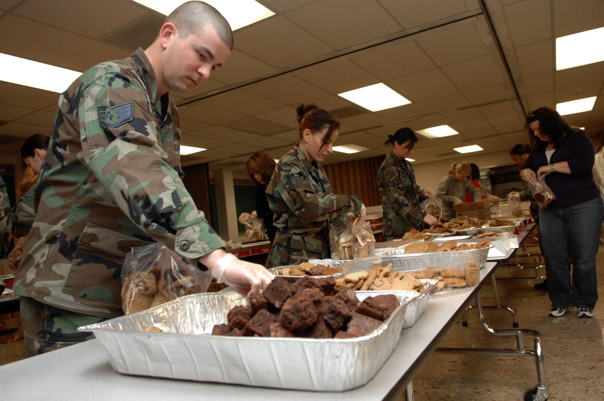 Nellis volunteers package cookies during the Nellis Airmen's Cookie Drive Dec. 17. The Airmen's cookie drive provides more than 1,000 single Airmen living in the dormitories, cookies for the holidays. (U.S. Air Force photo by Senior Airman Larry E. Reid Jr.)