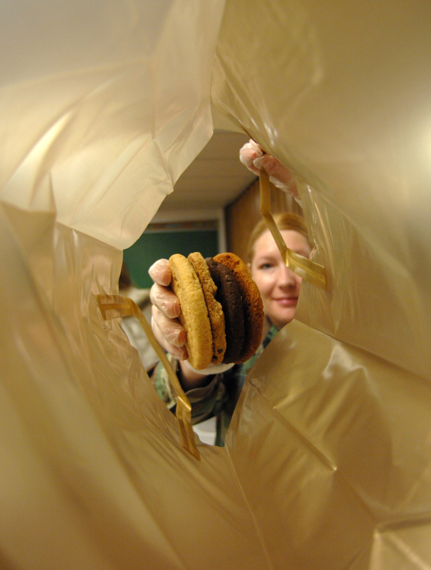 Tech. Sgt. Charlotte Peterson, 98th Range Wing Command Support Staff, packages cookies during the Nellis Airmen's Cookie Drive, Dec. 17. The Nellis Airmen's cookie drive provides more than 1,000 single Airmen living in the dormitories, cookies for the holidays. (U.S. Air Force photo by Senior Airman Larry E. Reid Jr.)