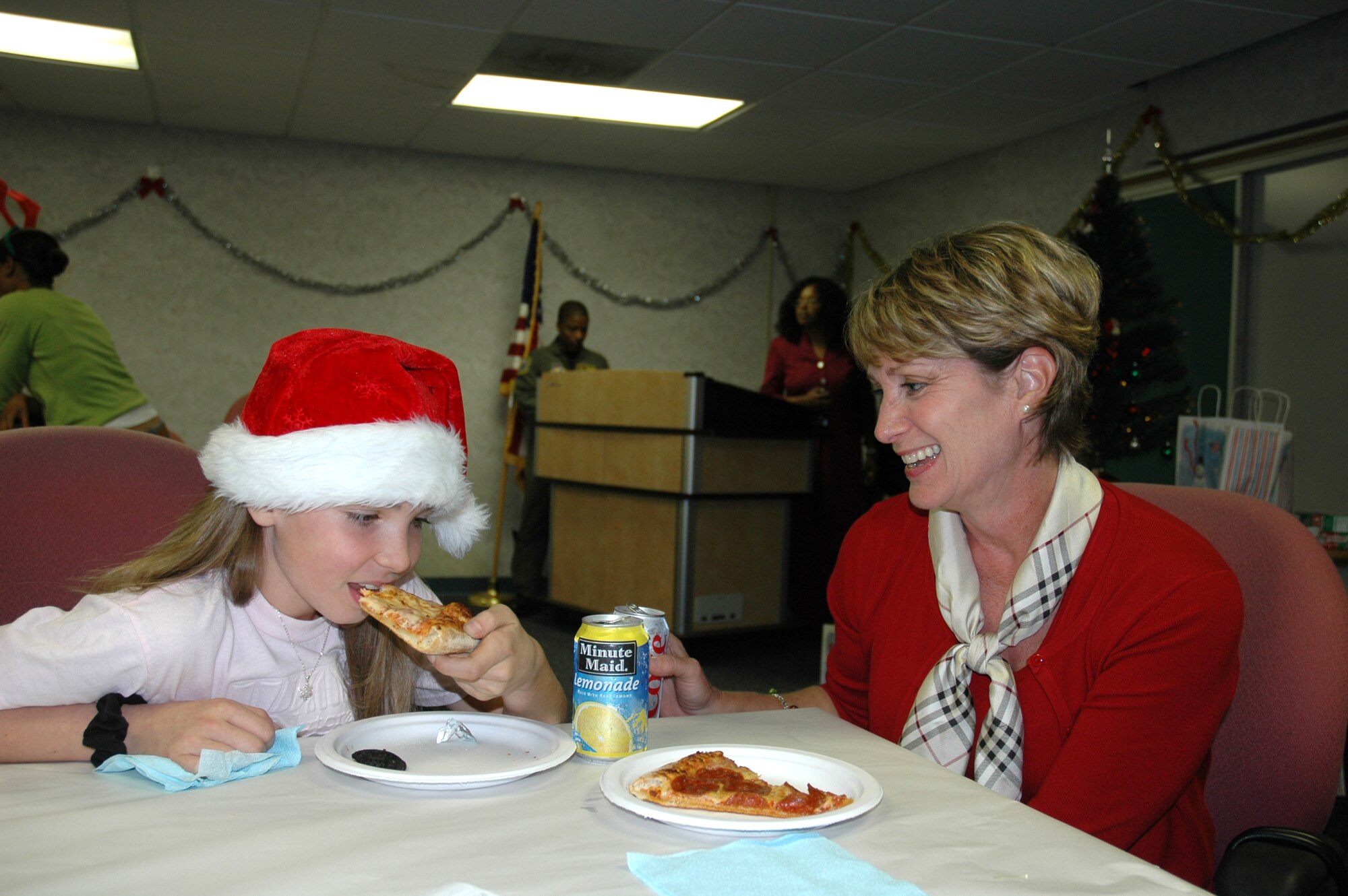 Lt. Col. Rita Uribe, 325th Fighter Wing assistant staff judge advocate, eats dinner with her daughter Katie at the "Hearts Apart" holiday party at the Airmen and Family Readiness Center here Dec. 13.  Colonel Uribe's husband, Lt. Col. Andy Uribe, Air Forces Northern chief of standerdization evaluation, is currently deployed as the 332nd Expeditonary Operations Group deputy commander.  (U.S. Air Force photo/Staff Sgt. Timothy R. Capling)