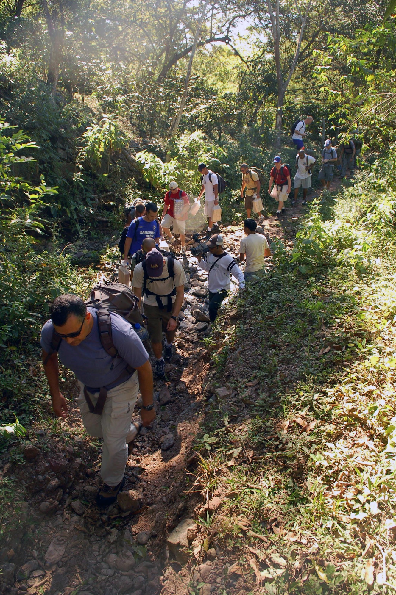 Servicemembers assigned to Joint Task Force-Bravo cross a stream en route to the village of Capiro to deliver approximately 600 pounds of food Dec. 14 in Honduras. The three-mile hike, sponsored by the JTF-Bravo chapel, was the fourth in a series of five scheduled trips. (U.S. Air Force photo/Staff Sgt. Austin M. May)
