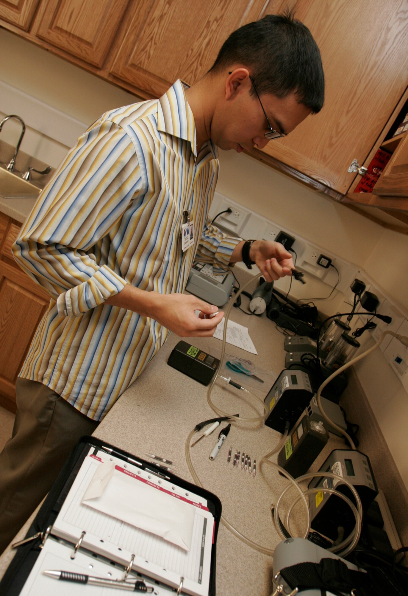 Ryan Fruto, bioenvironmental engineer technician, assesses paint-exposure hazards to determine the appropriate personal protective equipment Airmen should wear to help reduce health risks, Dec. 14. The new bioenvironmental building gives technicians the ability to conduct test and analysis on site, helping to save time in giving commanders critical information. (U.S. Air Force photo by Staff Sgt. Jacob R. McCarthy)