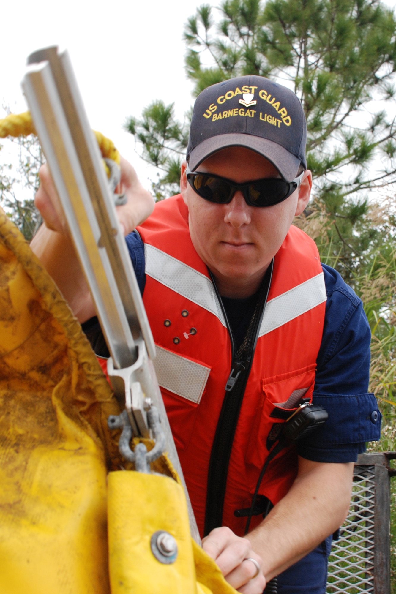 EGLIN AIR FORCE BASE, Fla. -- U.S. Coast Guard Boatswain Mate 2nd Class Jesse Duane, Barnegat Light, N.J., attaches two sections of boom together Dec. 14 to be deployed into Weekly Bayou during a fuel spill exercise. The Air Force and Coast Guard deployed more than 6,500 feet of boom during a week-long training exercise familiarizing them with the processes and equipment needed to clean up fuel spilled into the waters bordering Eglin's southern edge. Eglin has a water front bulk fuel storage facility that receives a barge of more than one million gallons of jet fuel every eight to 10 days. (U.S. Air Force photo by Staff Sgt. Mike Meares)