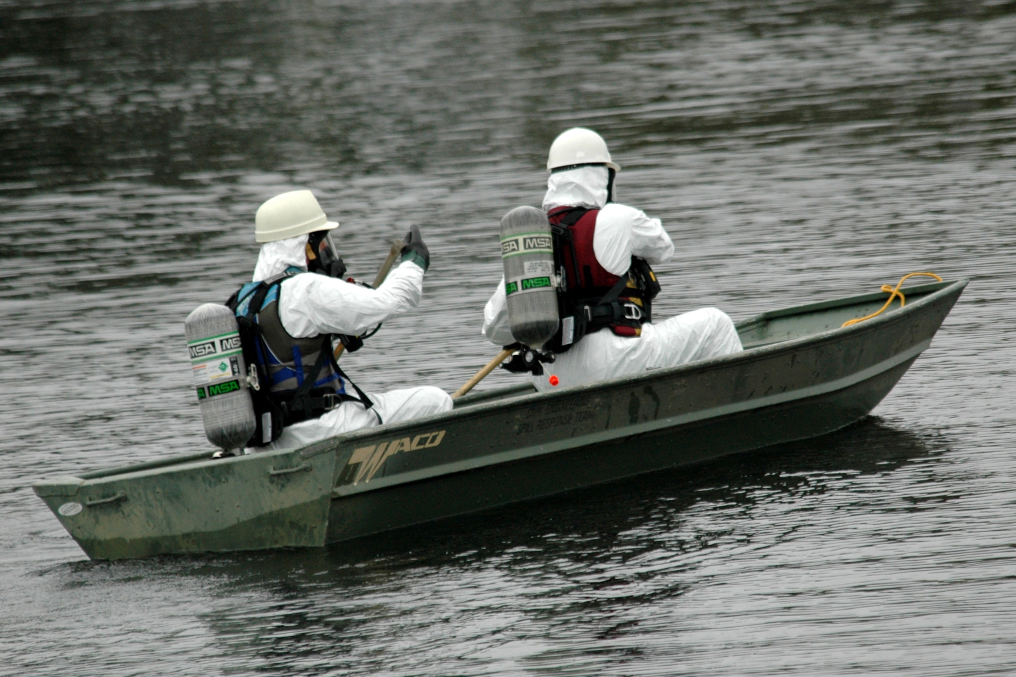 EGLIN AIR FORCE BASE, Fla. -- U.S. Coast Guard Marine Science Technician 1st Class Jay Matullonis and MST3 Joe O'Brien row a boat into the waters of Weekly Bayou to take readings of the fuel spill during the exercise Dec. 14. The Air Force and Coast Guard deployed more than 6,500 feet of boom during a week-long training exercise familiarizing them with the processes and equipment needed to clean up fuel spilled into the waters bordering Eglin?s southern edge. Eglin has a water front bulk fuel storage facility that receives a barge of more than one million gallons of jet fuel every eight to 10 days. (U.S. Air Force photo by Staff Sgt. Mike Meares)