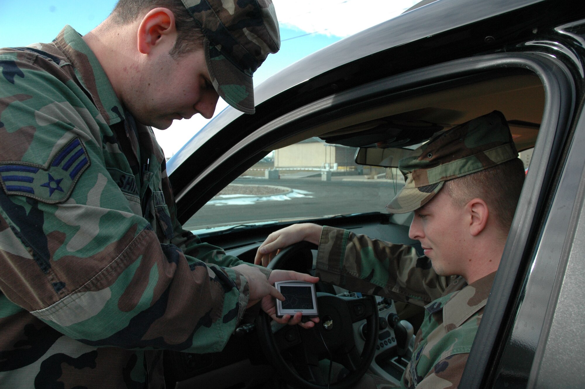 Senior Airman Joseph Shirkey, 341st Missle Maintenance Squadron and organizer of the Airmen Against Drunk Driving program, helps Senior Airman Justin Bigham, 341st MMXS and assistant organizer of AADD, program the GPS prior to an AADD shift. (U.S. Air Force photo/Airman 1st Class Emerald Ralston)