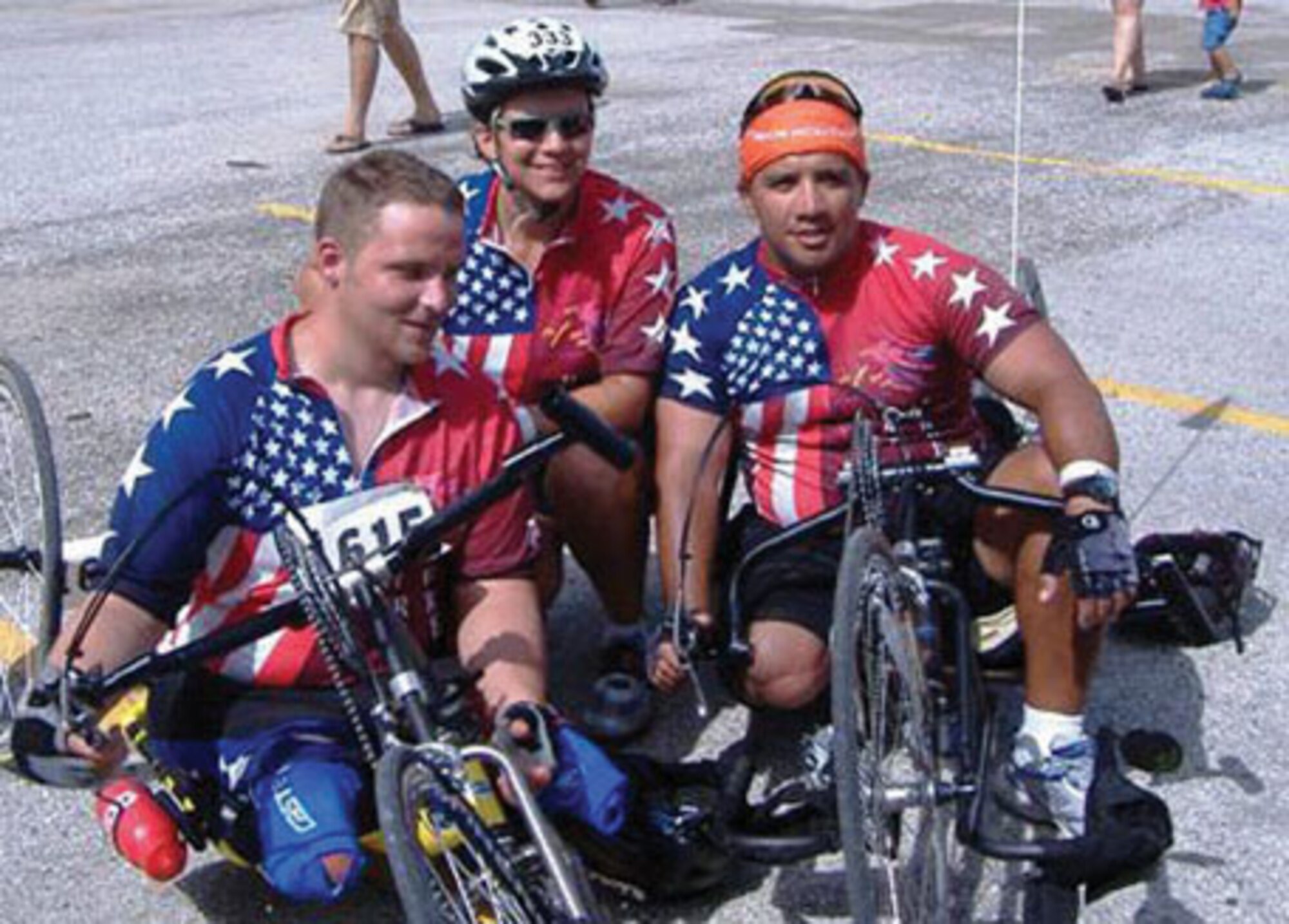 Stephanie Melton, wife of Reserve Capt. Christopher Melton, a C-5 pilot with the 68th Airlift Squadron, takes a break with two riders during the MS 150 Bike to the Beach. The two riders are both amputees wounded during the war on terror. The Meltons rode as support riders for members of a team made up of amputee patients at the Center for the Intrepid in San Antonio. (Courtesy Photo)