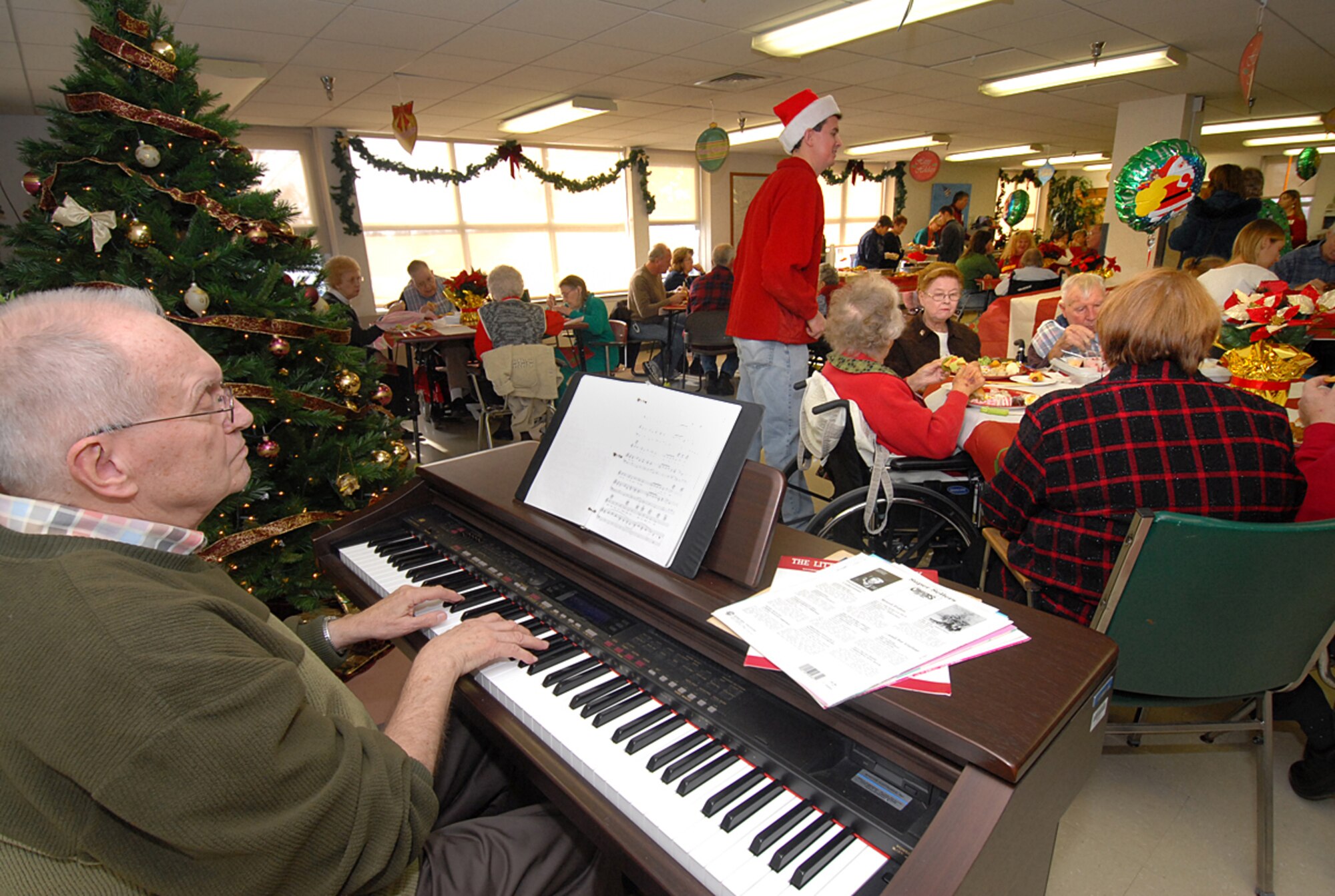 SCOTT AIR FORCE BASE, Ill. -- Retired veteran Russell Goodell plays some holiday tunes during the annual "Christmas with the Vets" visit at the Quincy Illinois Veteran's Retirement Home. (U.S. Air Force photo by Marv Lynchard)