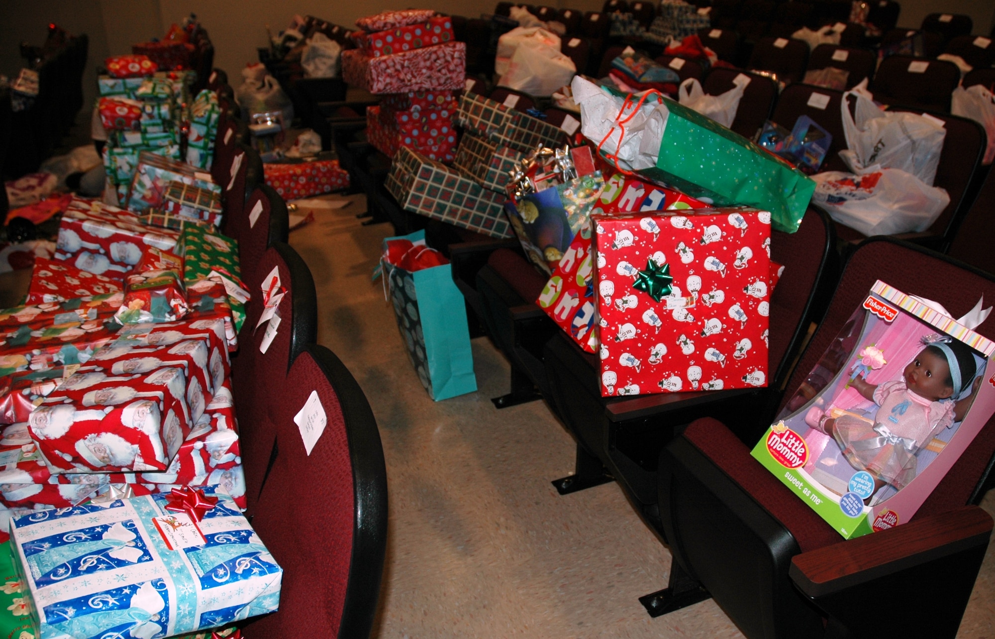 The 16th Special Operations Squadron auditorium overflows with gifts donated to Hurlburt Field Angel Tree children Dec. 15. The Company Grade Officers' Council collected and wrapped $6,500 worth of donated toys, clothing and baby supplies, which will benefit 175 children from 20 squadrons across the base. (U.S. Air Force photo/2nd Lt. Lauren Johnson)