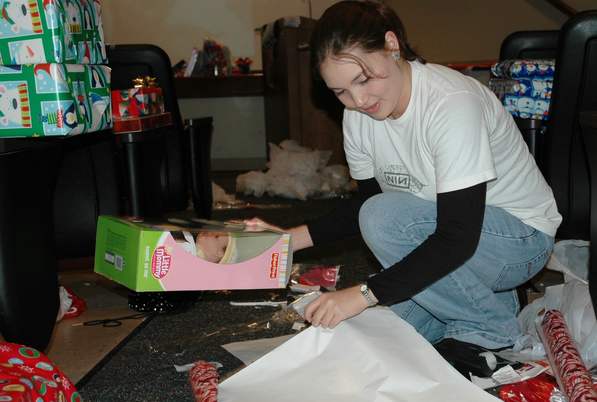 2nd Lt. Kristen Granger, 1st Special Operations Medical Group, wraps a doll for a Hurlburt child as part of the Company Grade Officers' Councils' Angel Tree program. Base and community members donated $6,500 worth of gifts, which will benefit 175 children from 20 squadrons across the base. (U.S. Air Force photo/2nd Lt. Lauren Johnson)