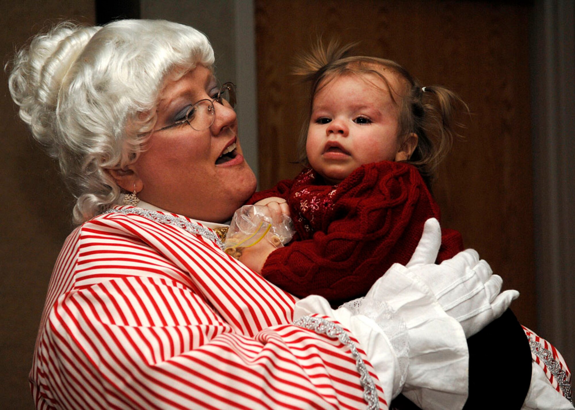 SCOTT AIR FORCE BASE, Ill. -- Tori Boschert, daughter of a Joint Total Force Scott servicemember, meets Mrs. Claus at  Our Lady of the Snows Shrine Dec. 14 during the Hearts Apart Holiday Event. (U.S. Air Force photo by Airman 1st Class Megan Gilliand)