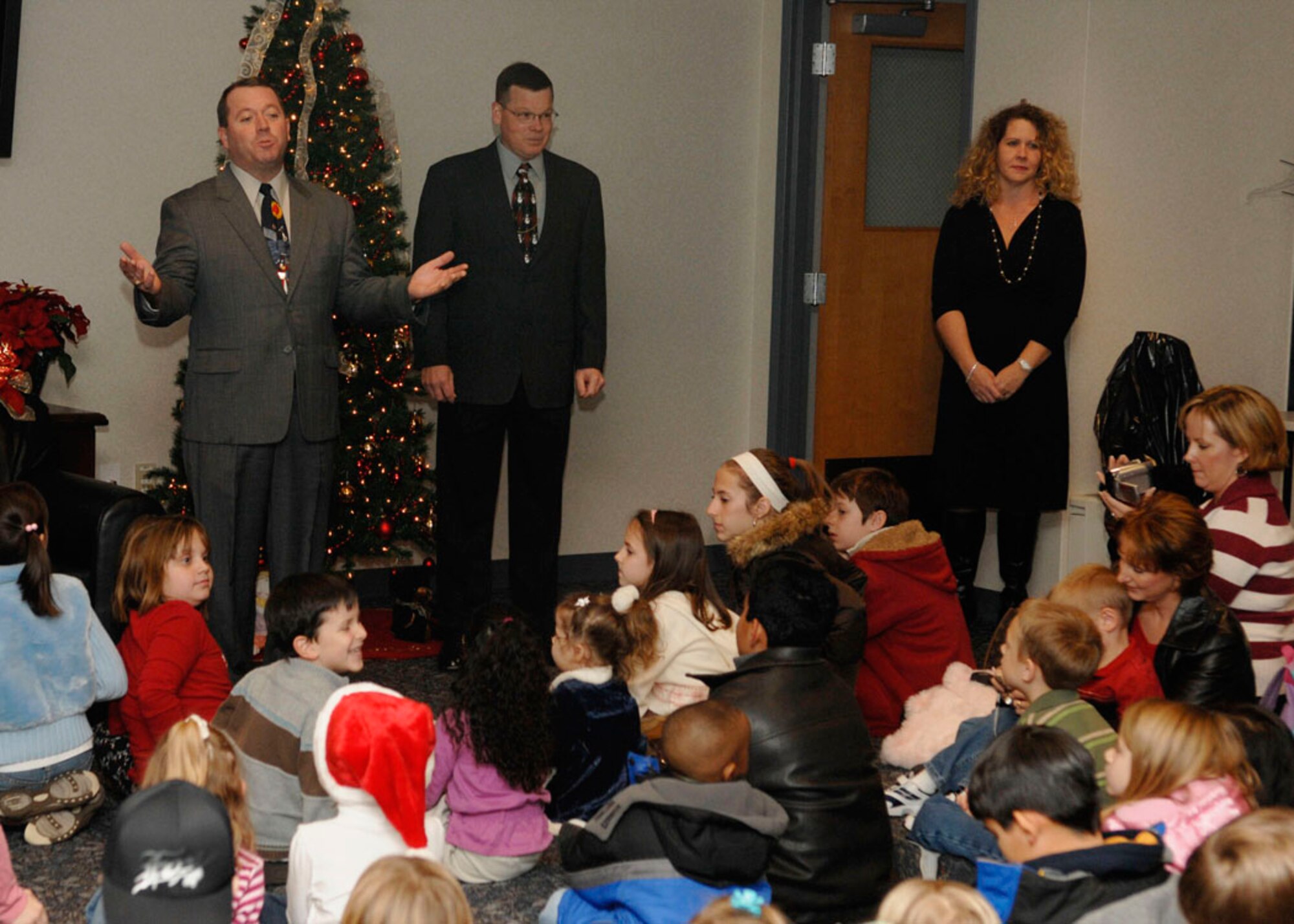 SCOTT AIR FORCE BASE, Ill. -- Col. Al Hunt, 375th Airlift Wing commander, and Chief Master Sgt. James Suttles, 375th AW command chief, speak to children at the Airman and Family Readiness Center Dec. 14 during the Hearts Apart Holiday Event. (U.S. Air Force photo by Airman 1st Class Megan Gilliand)