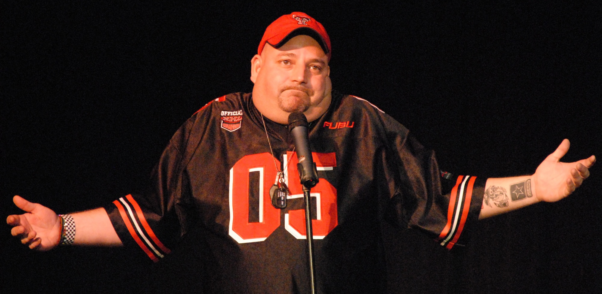 GUANTANAMO BAY NAVAL STATION, Cuba -- Comedian Scott Kennedy performs on stage here as part of a United Service Organizations tour.  Mr. Kennedy was accompanied by the 12th Air Force "Cookie Caper," a morale mission allowed 12th Air Force leaders to visit with deployed servicemembers prior to the holidays. The team delivered more than 9,000 cookies to Honduras, the Netherlands Antilles, Puerto Rico, and Guantanamo Bay Naval Station, Cuba. (U.S. Air Force photo by Tech. Sgt. Sonny Cohrs)