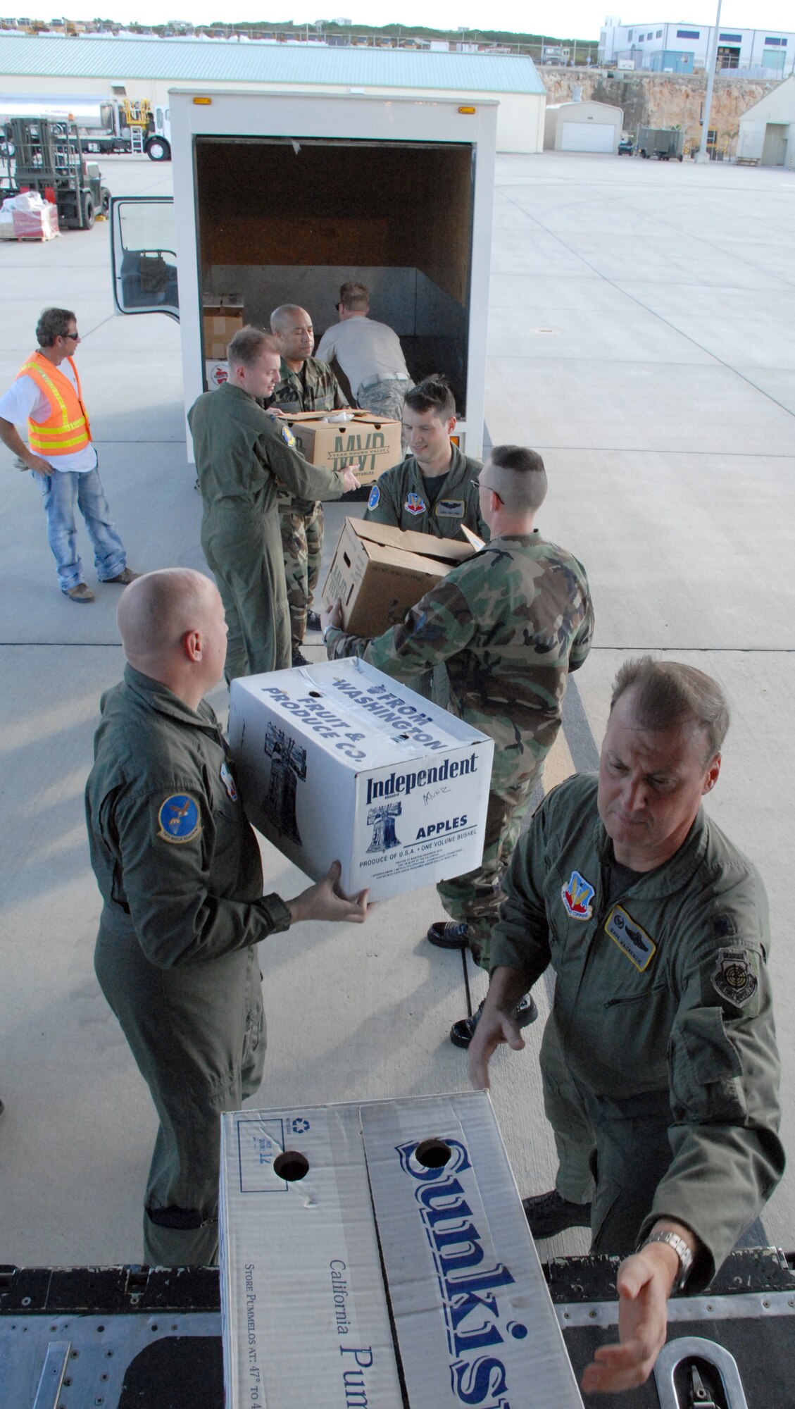 CURACAO, The Netherlands Antilles -- Aircrew from the 79th Rescue Squadron unloads boxes of cookies from an HC-130 here Dec. 12.  The ?Cookie Caper? morale mission allowed 12th Air Force leaders to visit with deployed servicemembers prior to the holidays. The team delivered more than 9,000 cookies to Honduras, the Netherlands Antilles, Puerto Rico, and Guantanamo Bay Naval Station, Cuba. (U.S. Air Force photo by Tech. Sgt. Sonny Cohrs)