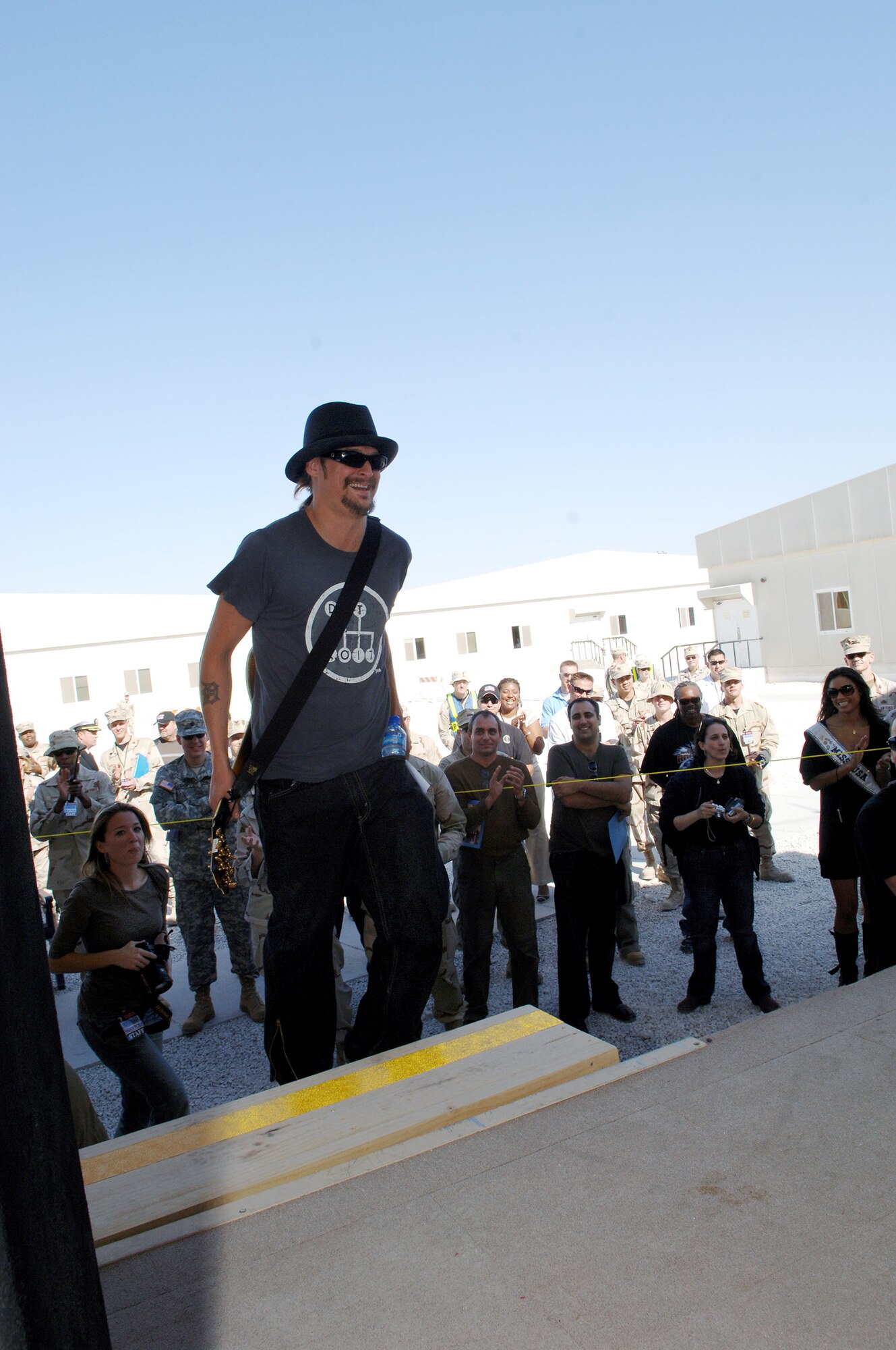 Kid Rock enters the stage right before performing for troops at the 379th Air Expeditionary Wings Memorial Plaza Dec. 17 at a Southwest Asia air base. He is part of the United Service Organizations 2007 holiday tour. (U.S. Air Force photo/Master Sgt. Greg Kunkle) 
