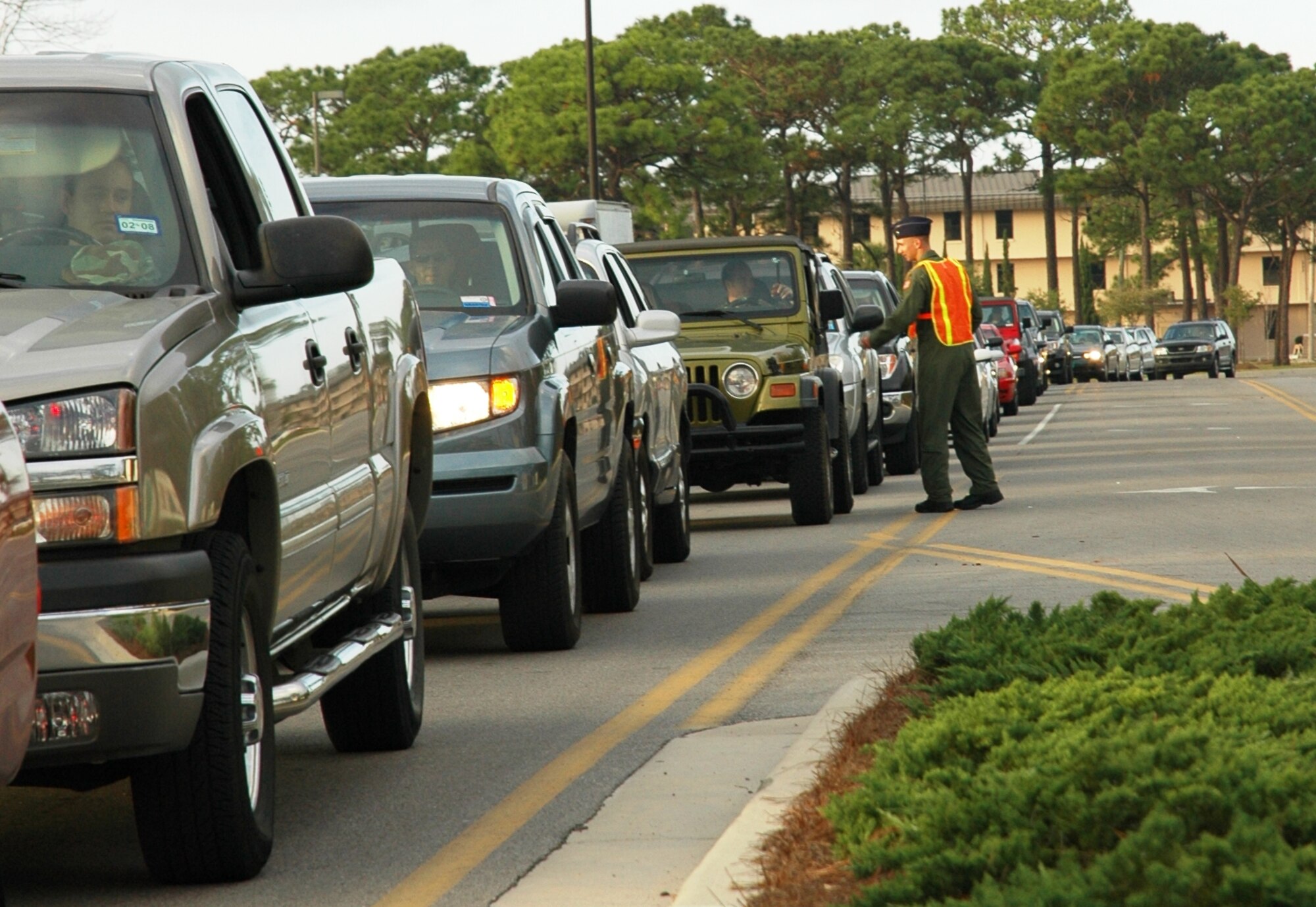 2nd Lt. David Scott, 20th Special Operations Squadron, hands out stress balls to a long line of cars at the Hurlburt Field main gate Dec. 14. Members of the Company Grade Officer’s Council distributed 1,200 balls in support of Hurlburt's holiday DUI-prevention campaign. Each stress ball lists the Airmen Against Drunk Driving phone number. (U.S. Air Force photo/2nd Lt. Lauren Johnson)