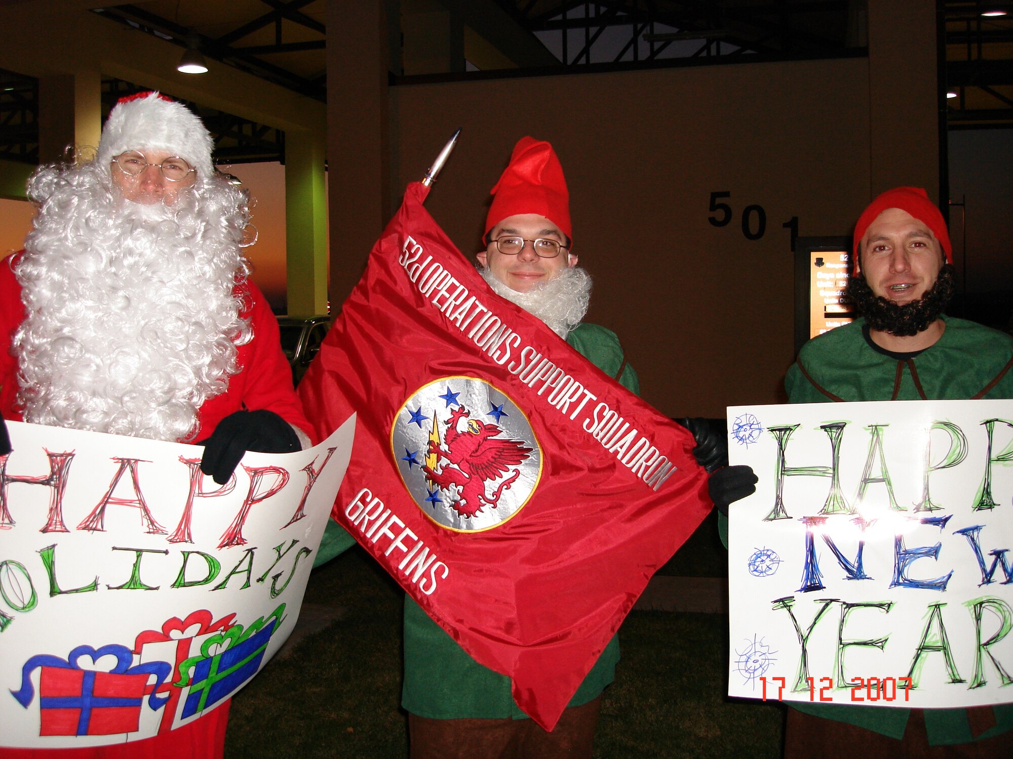 SPANGDAHLEM AIR BASE, Germany – (Left to right) Maj. Michael Fitzpatrick, Master Sgt. Christopher Frost and Capt. Ryan Guess, all from the 52nd Operations Support Squadron, spent time at the Spangdahlem AB main gate wishing fellow Sabers a Happy Holiday Season Dec. 15. They won the privilege of doing this through a squadron fundraiser to help ensure unit members could attend the squadron’s holiday functions at no cost. (U.S. Air Force photo/Master Sgt. Paul Denton)