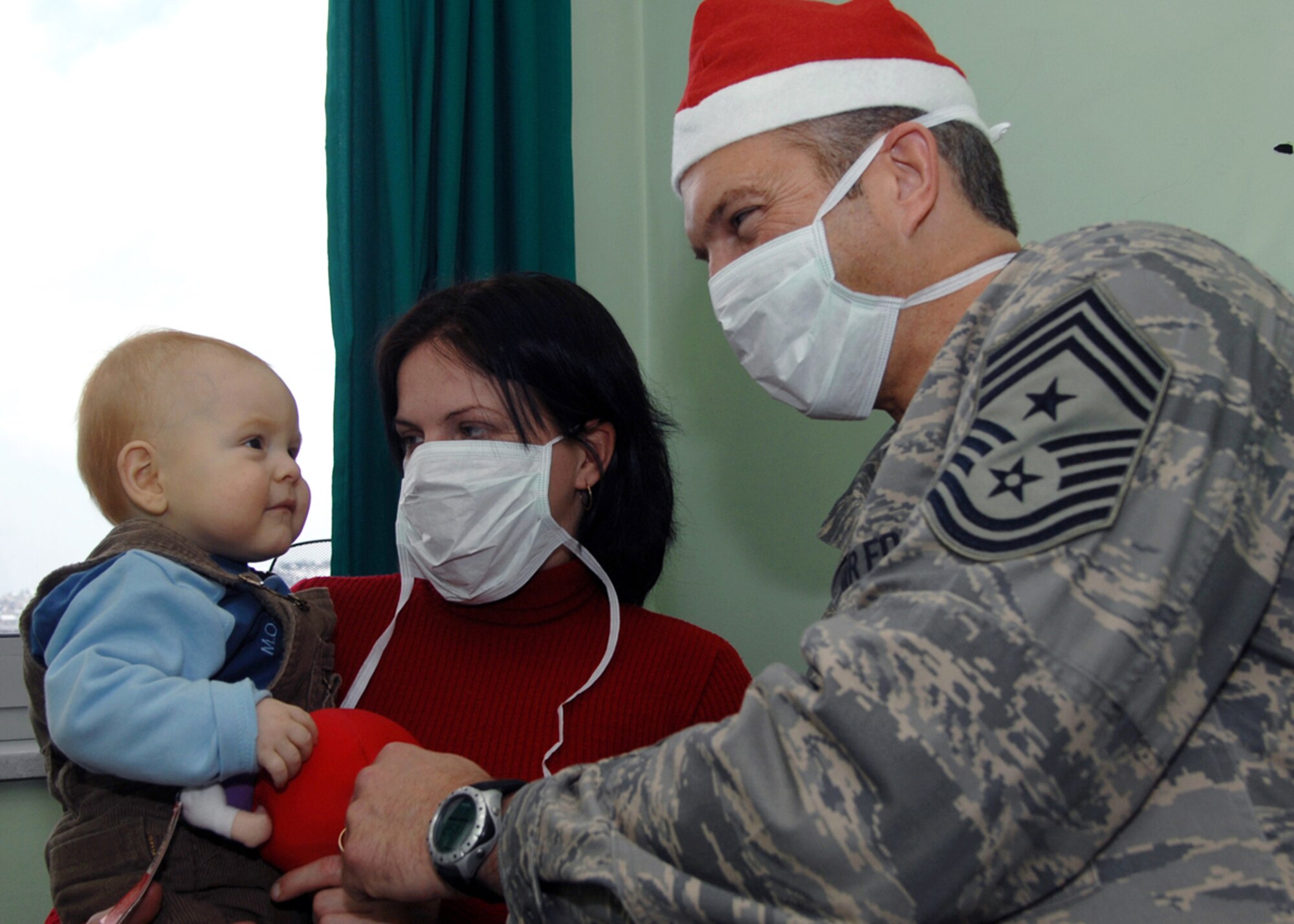 Chief Master Sgt. Martin Klukas, 3rd Air Force command chief, played Santa Claus by delivering Christmas presents to young patients in a Sarajevo children's hospital Dec. 17.  The chief's presence was part of a large 3rd Air Force effort. The unit collected and delivered Christmas gifts to more than 120 children. (Photo by Senior Master Sgt. Hollis Dawson)