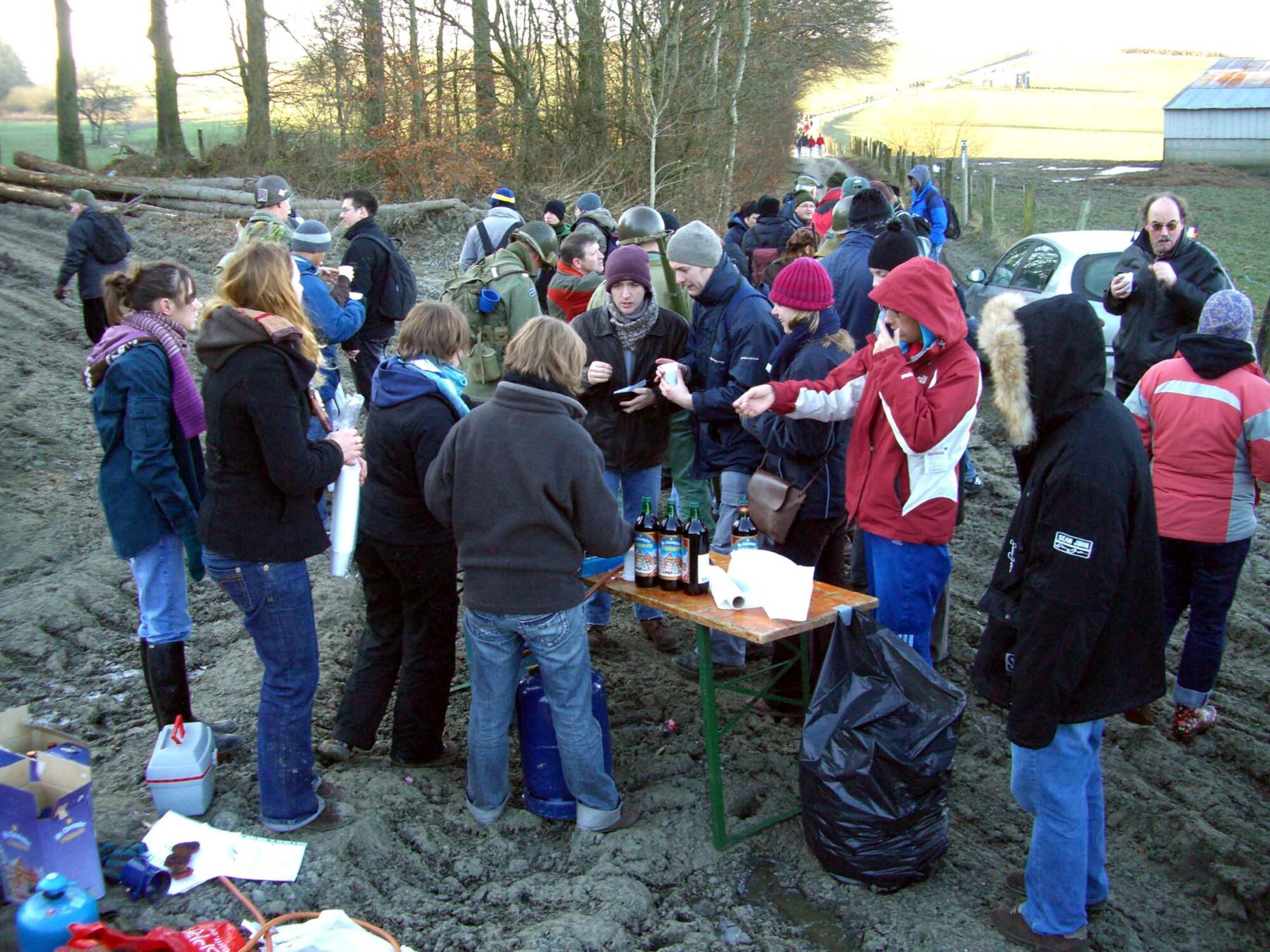 BASTOGNE, Belgium -- Re-enactors and other marchers brave the cold and mud at a checkpoint during the 63rd anniversary 20 kilometer march of the Battle of the Bulge in Bastogne, Belgium Dec. 15, 2007. (U.S Air Force photo/Capt. Kevin Coffman)