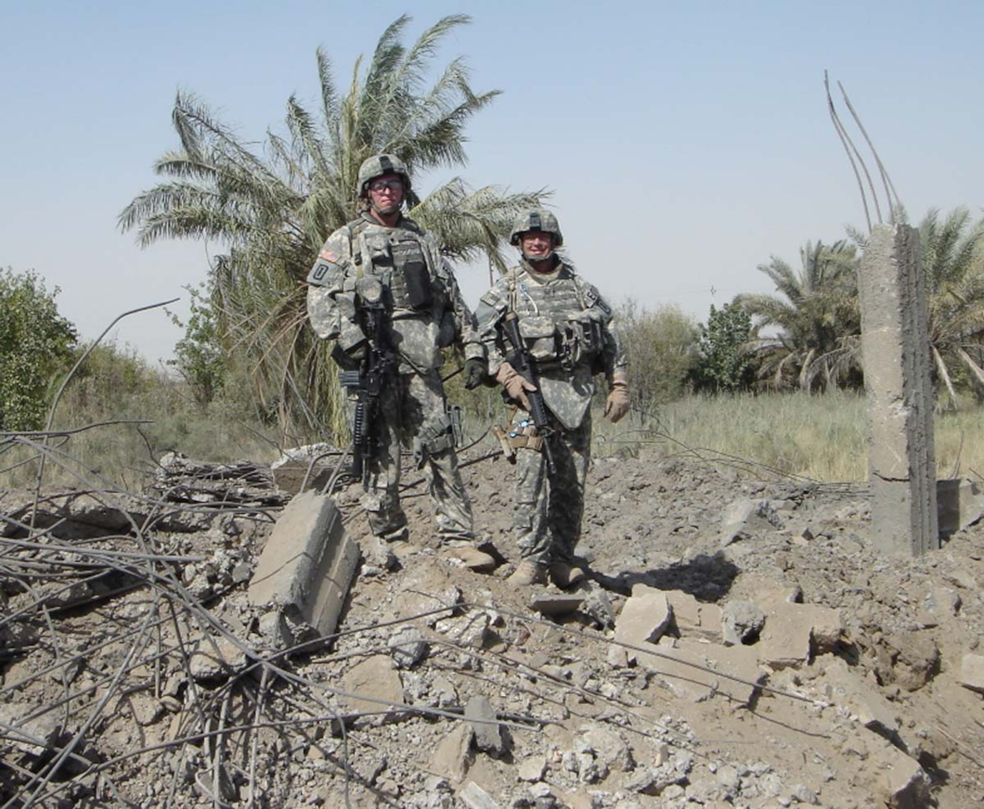 Iraq – Senior Master Sgt. Ken Pettibone and a coworker stand on the remnants of a house that was being used repeatedly for attacks against coalition forces. According to locals, the house had been abandoned for more than 15 years. Sergeant Pettibone was about 500 meters away while the Air Force dropped five each Mk 82 500 lb bombs on the house. Sergeant Pettibone and his team then went in to ensure there were no IED components. He earned his second Bronze Star medal for his work during his second tour in Iraq. (Courtesy photo)