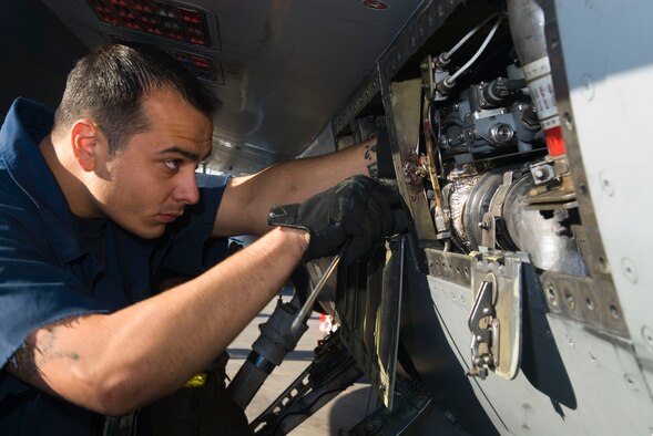 BALAD AIR BASE, Iraq -- Staff Sgt. Mario Vanore, a 332nd Expeditionary Aircraft Maintenance Squadron electronics and environmental technician, performs maintenance on the bleed air distribution for the Environmental Control System of an F-16 Fighting Falcon here, Dec. 17. The bleed air distribution sends hot air from the aircraft engine to the ECS to create cabin pressure for the cockpit. Sergeant Vanore is deployed from Hill Air Force Base, Utah. (U.S. Air Force photo/Staff Sgt. Joshua Garcia)