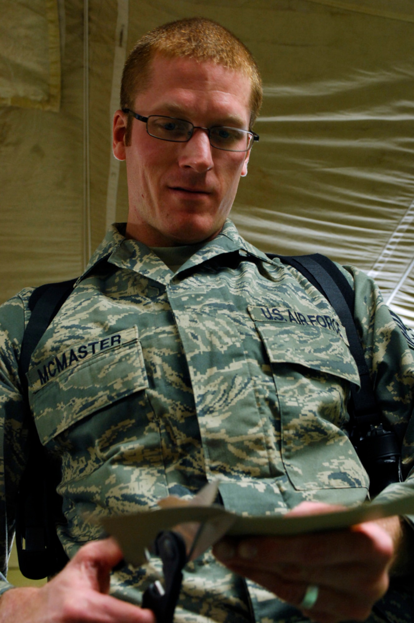 BAGRAM AIR BASE, Afghanistan - Tech. Sgt. Ryan McMaster, an aircrew life support technician with the 774th Expeditionary Airlift Squadron here, cuts out cartoon characters for a holiday diorama he created from locally-procured materials, Dec. 14, 2007.   (U.S. Air Force photo/Staff Sgt. Joshua T Jasper)