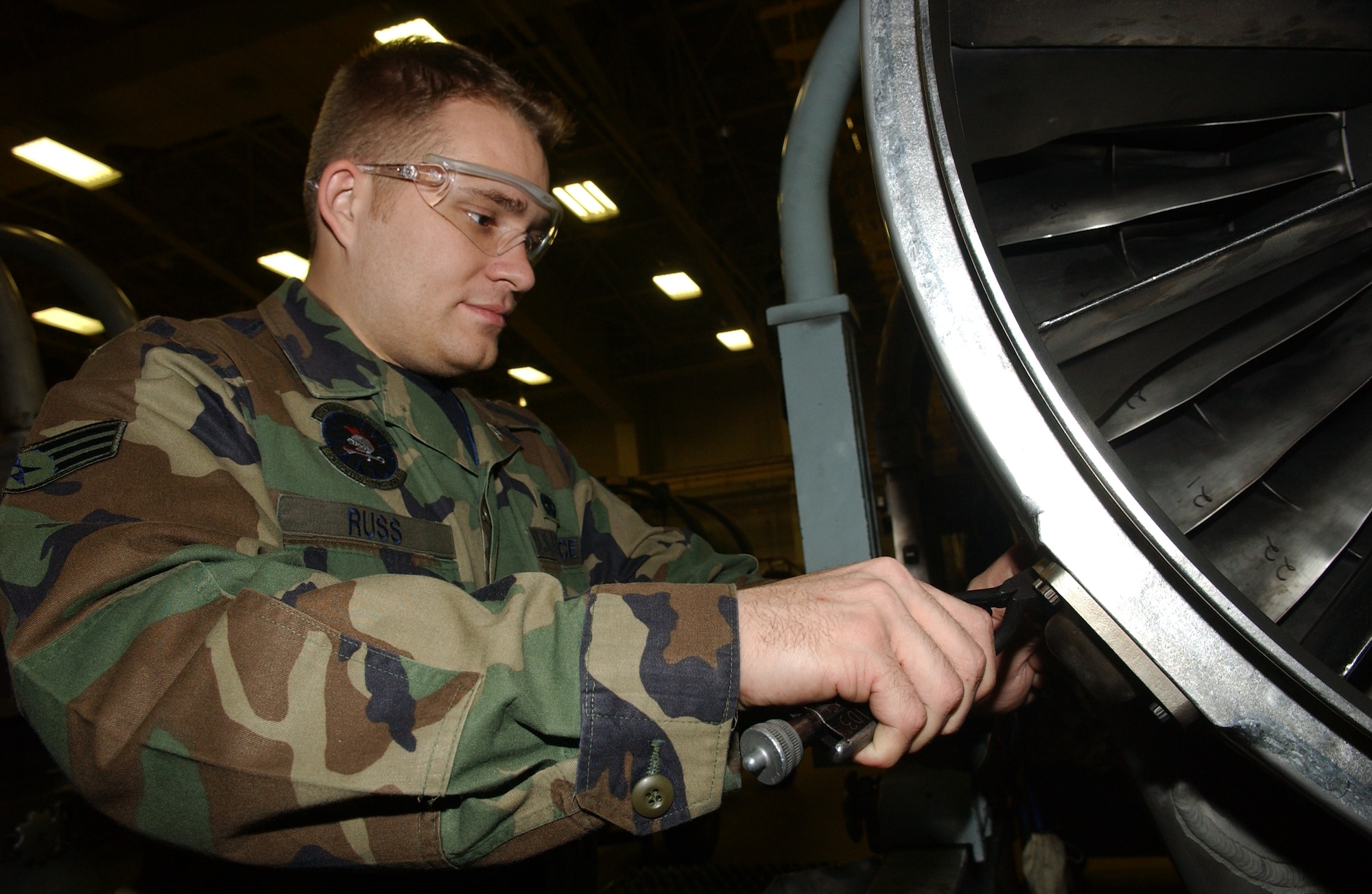 071214-F-0108B-004 MISAWA AIR BASE, Japan -- Senior Airman Robert Russ, 35th Maintenance Squadron, fixes a drain plug on an F-16 jet engine.  Airman Russ is an assistant crew chief for the propulsion flight, also known as the Queen Bee, fixing F-16 engines for Misawa, Osan, and Kunsan Air Base.
(U.S. Air Force photo by Senior Airman Robert Barnett)