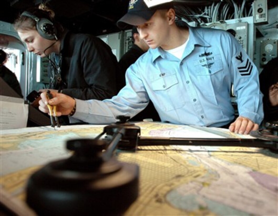 U.S. Navy Petty Officer 1st Class John Kemp measures with a pair of dividers as he plots the course of the amphibious assault ship USS Boxer (LHD 4) as the ship pulls out of San Diego, Calif., on Dec. 11, 2007.  Kemp is a Navy quartermaster onboard the Boxer.  