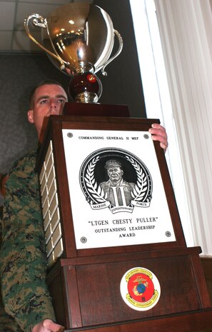 A Marine stands with the ?Lt. Gen. Chesty Puller? Outstanding Leadership Award  before presenting it to the Marines and Sailors of 2nd Medical Battalion during an award ceremony, here, Dec. 19.  The battalion was presented the award for professional achievement and superior performance in training, equipping, maintaining, fostering, nurturing and mentoring Marines and Sailors, as well as exceeding mission requirements from Oct. 1, 2006 to Sept. 30, 2007.