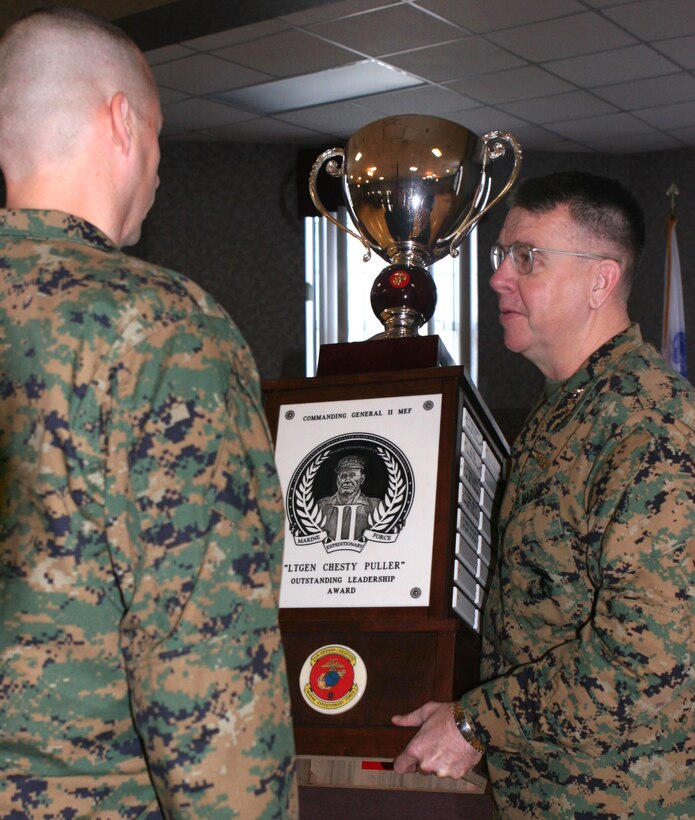 Lt. Gen. Keith J. Stalder, commanding general of II Marine Expeditionary Force, presents the ?Lt. Gen. Chesty Puller? Outstanding Leadership Award to the Marines and Sailors of 2nd Medical Battalion, 2nd Marine Logistics Group, here, Dec. 19.  The battalion was presented the award for professional achievement and superior performance in training, equipping, maintaining, fostering, nurturing and mentoring Marines and Sailors, as well as exceeding mission requirements from Oct. 1, 2006 to Sept. 30, 2007.