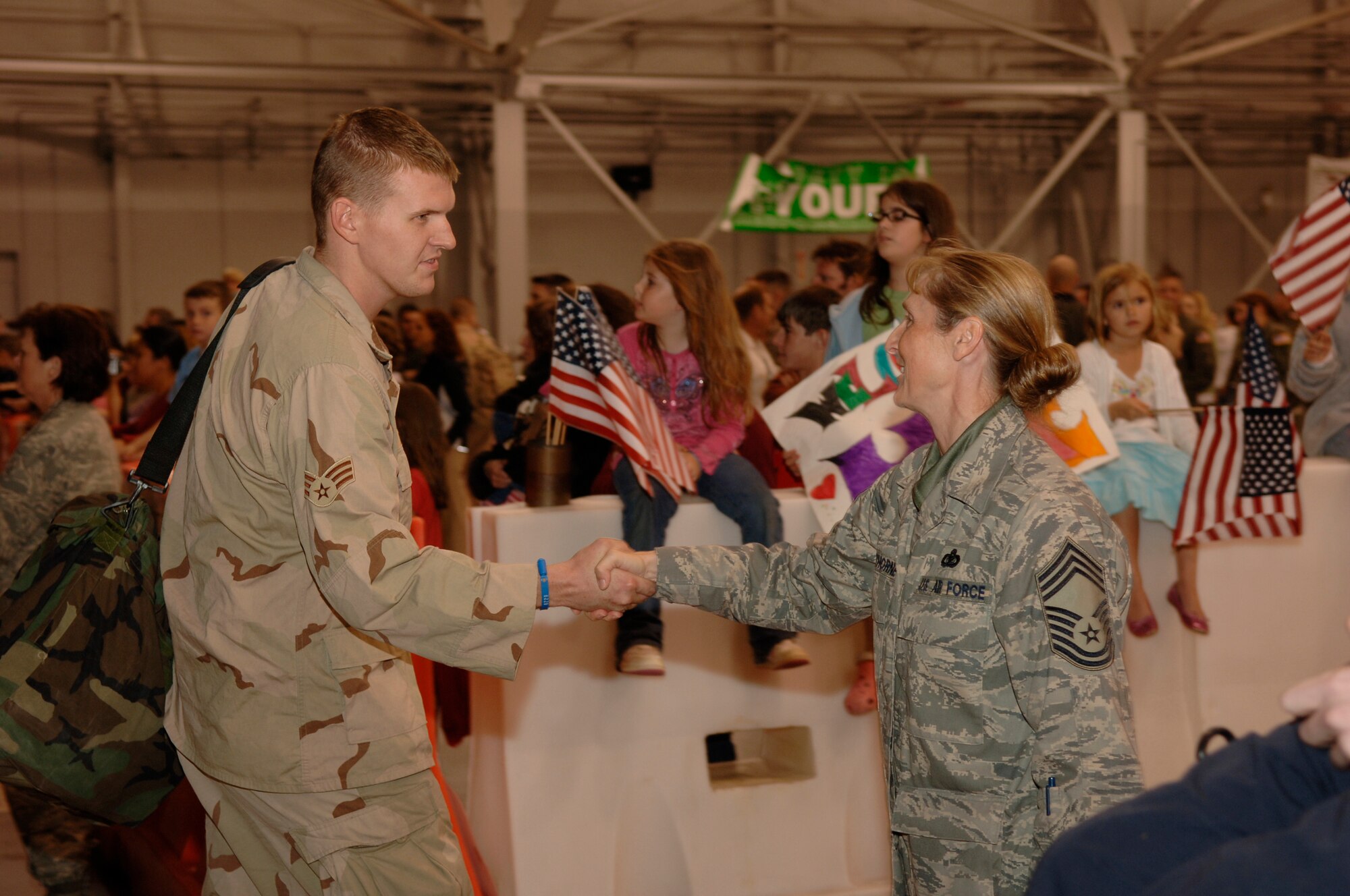Chief Master Sgt. Diane Hawthorne, 1st Special Operations Mission Support Group, greets a returning Airman during the "Operation Homecoming" Dec. 7 at Hurlburt Field. Operation Homecoming is a ceremony dedicated to supporting the men and women returning from deployment overseas.  (U.S. Air Force photo/Airman 1st Class Matthew Loken)