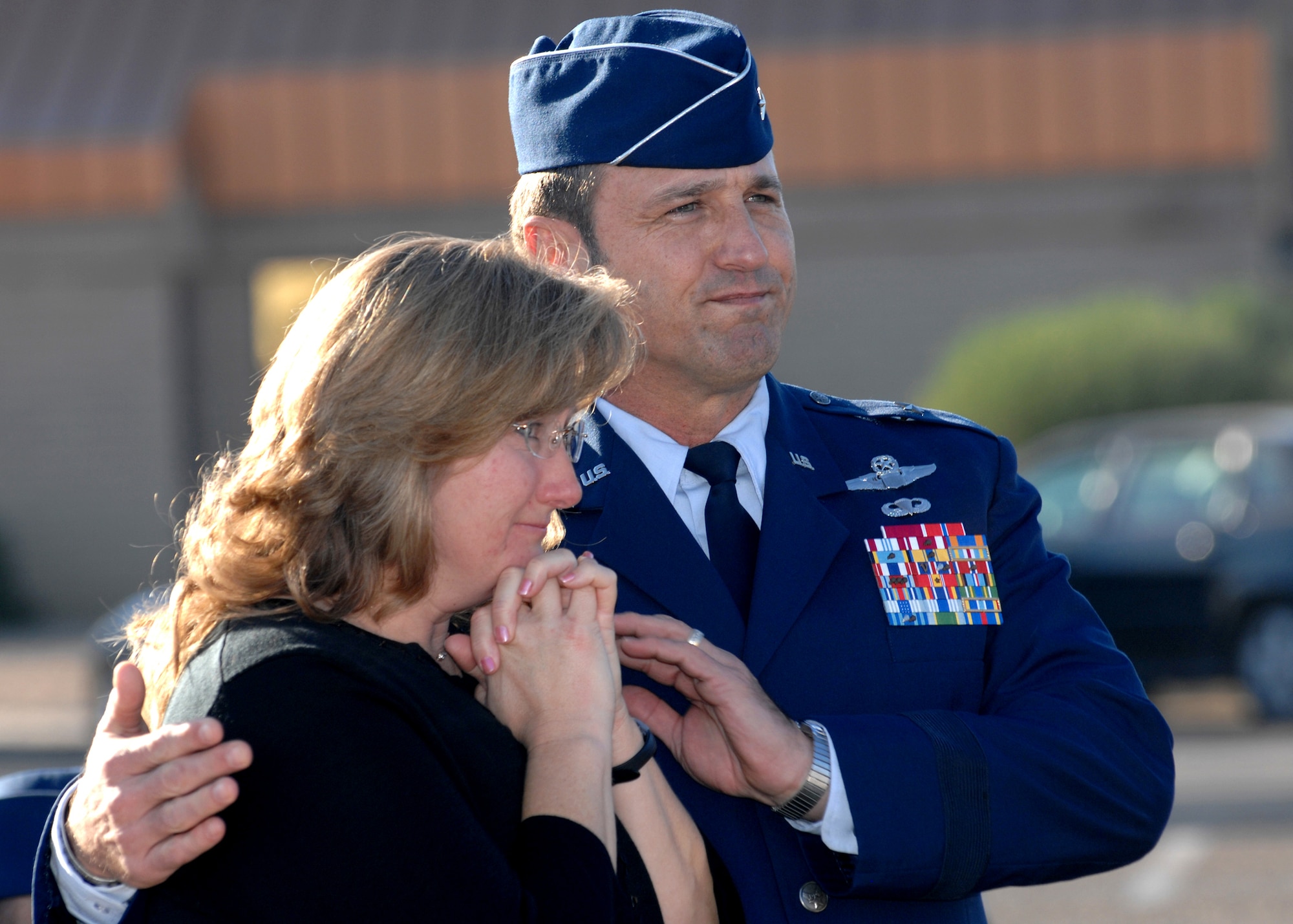 Brig. Gen. Tom Jones, 56th Fighter Wing commander, comforts Lisa Gillespie, wife of Master Sgt. Randy Gillespie, after the street sign revealing the newly-named Gillespie Drive was unveiled Dec. 18. Sergeant Gillespie was killed in action July 9, 2007. (photo by Tech. Sgt. Raheem Moore)