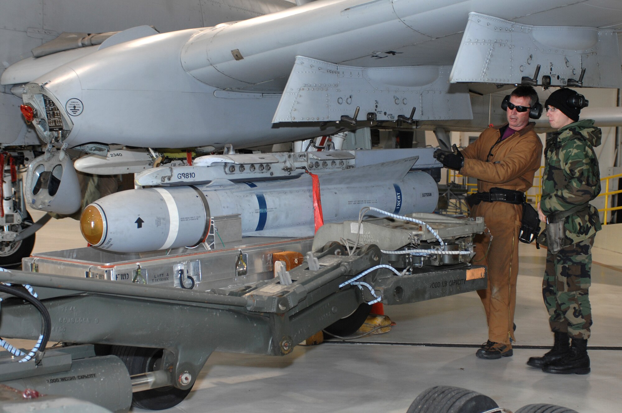 WHITEMAN AIR FORCE BASE, Mo. -- Master Sgt. Jim Kirksey, 442nd Aircraft Maintenance Squadron, keeps the TGM 65 Maverick missile level while it is being pulled away by Tech. Sgt. Ken Portell, 442nd Aircraft Maintenance Squadron, drives a jammer Dec. 19. (U.S. Air Force photo/Tech. Sgt. Samuel A. Park)