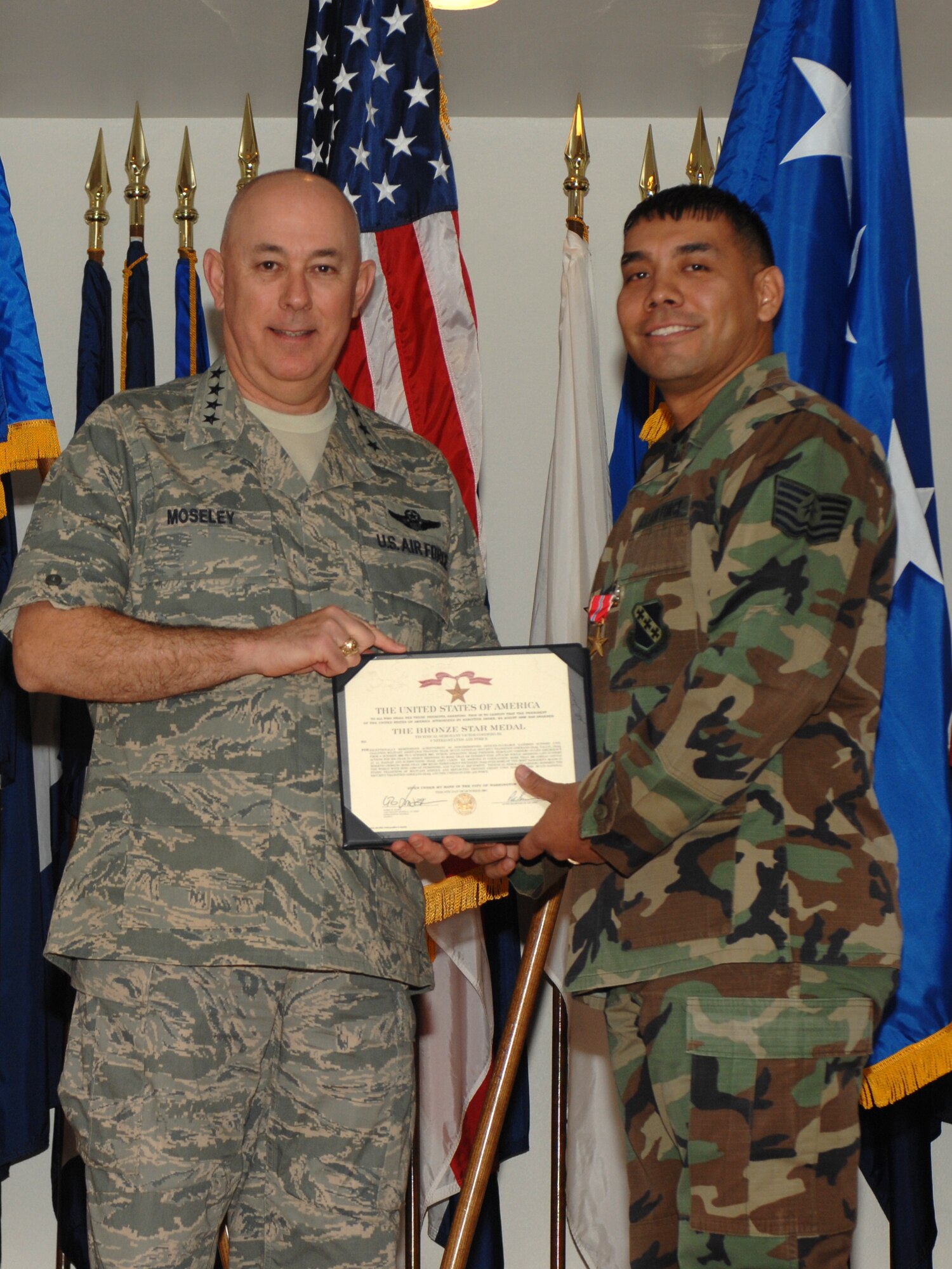 Gen. T. Michael Moseley, Air Force chief of staff, presents the Bronze Star Medal to Tech. Sgt. Victor Cordero, 7th Communications Squadron. Sergeant Cordero performed more than 100 missions while deployed with coalition forces in Iraq. (U.S. Air Force photo by Senior Airman Courtney Garrard)