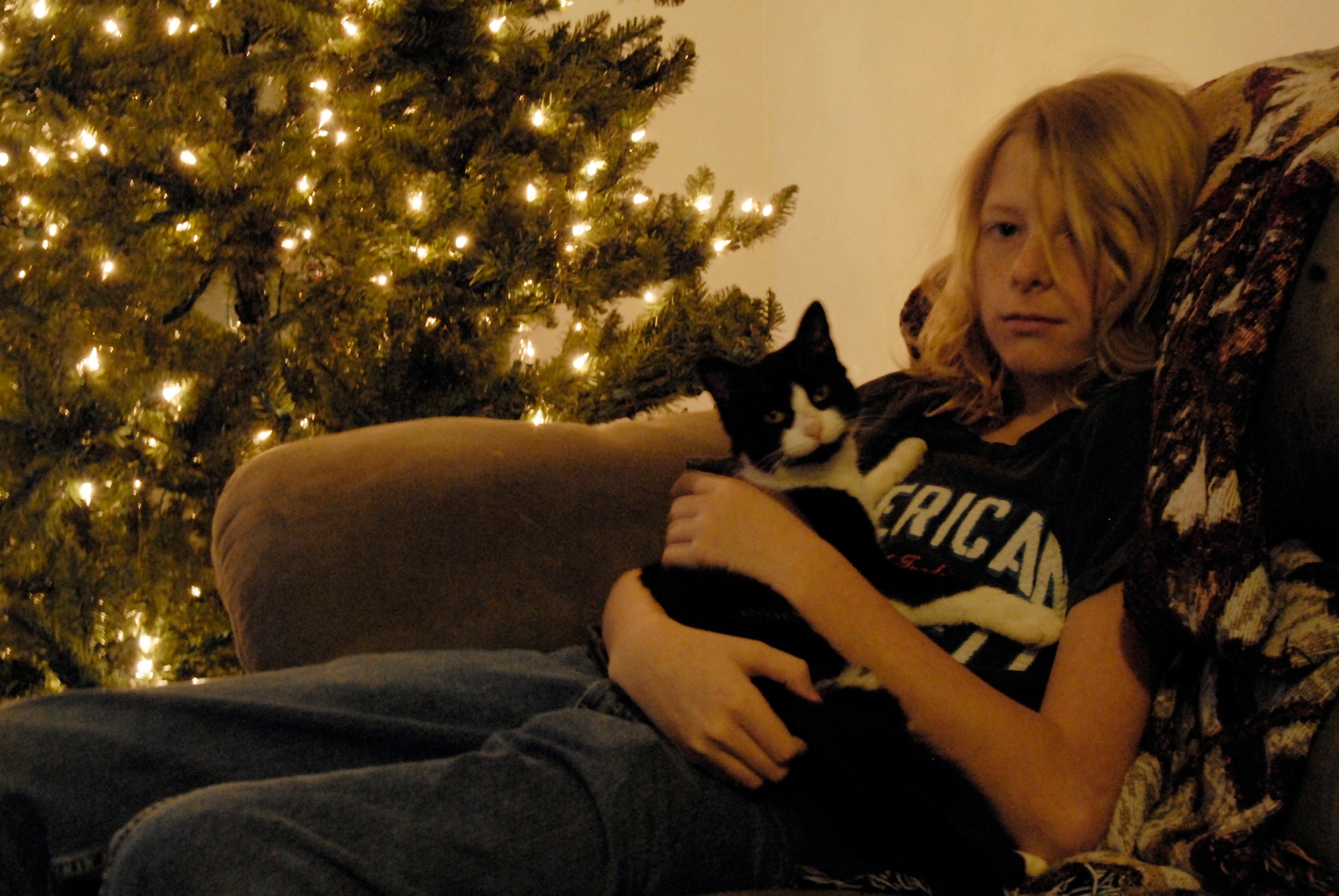 HANSCOM AFB, Mass. -- Cody Brooks, 13, son of Tech. Sgt. Donnie Brooks, 66th Security Forces Squadron, holds his kitten, Meow, in his base home Dec. 18. Meow was lost this past August, but was found by a base resident Dec. 11, and was turned in to the Hanscom Veterinary Treatment Facility. Thanks to the microchipping Meow received from the clinic last year, the kitten was identified and reunited with the Brooks family before Christmas. (U.S. Air Force photo by 2nd Lt. C. Michaela Walrond.)