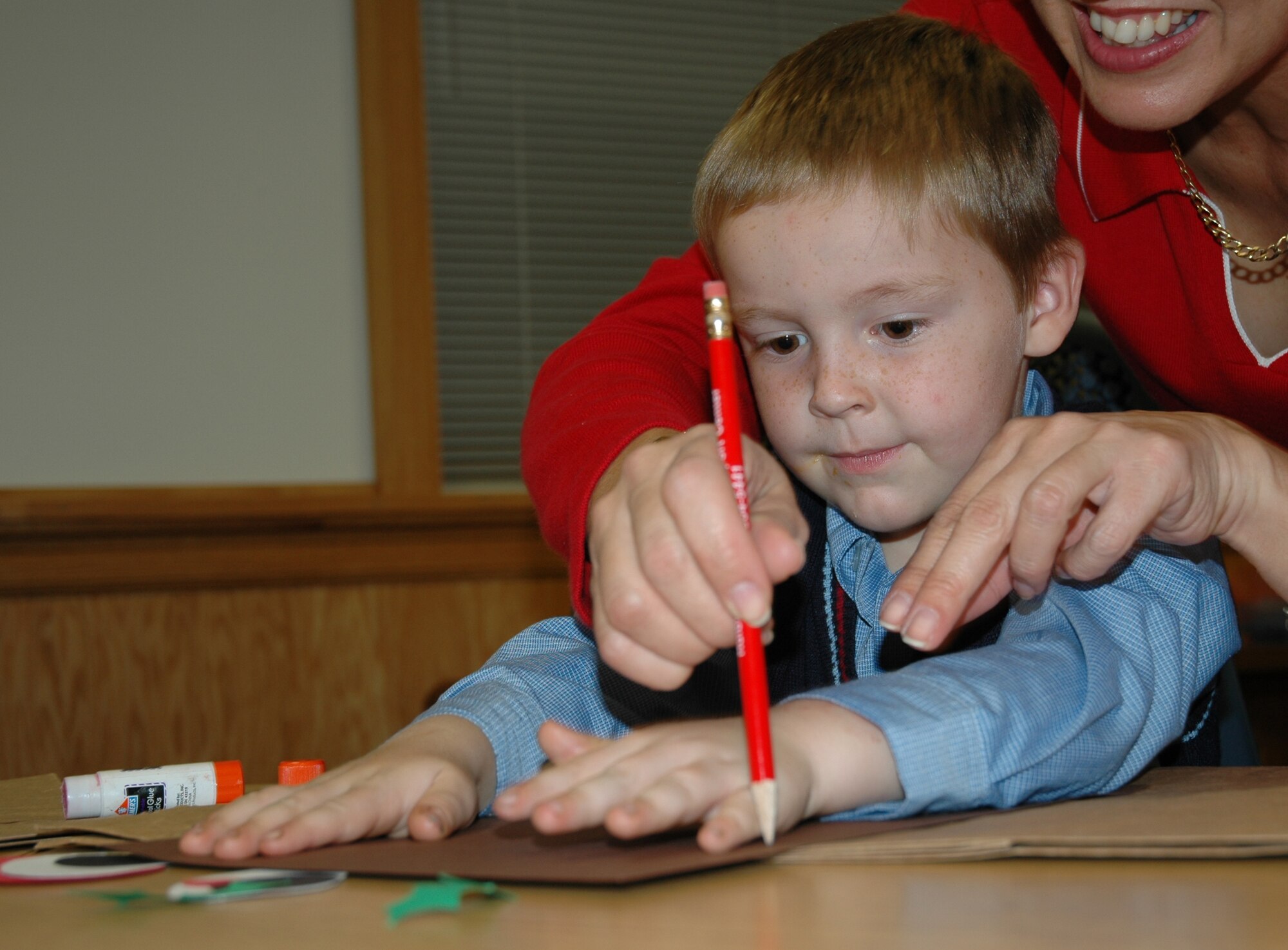 Four-year-old Colin Rinck makes antlers for his reindeer during the Hearts Apart Holiday Party at the Airman & Family Readiness Center Dec. 14. The annual event is one of the monthly activities planned by the A&FRC to keep families in touch with deployed and remotely assigned Airmen. (U.S. Air Force photo/Tech. Sgt. Kristina Newton) 