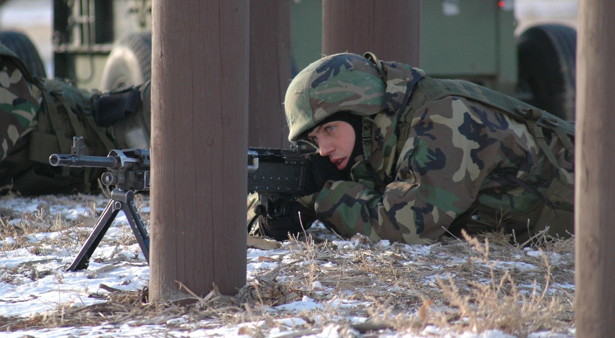 Airman 1st Class Jason Field, 341st Security Forces Squadron member, provides cover for others apprehending non-violent foreign nationals who were attempting to enter the base during an expeditionary readiness exercise at Camp Grizzly Dec. 12. (U.S. Air Force photo/Airman 1st Class Dillon White)