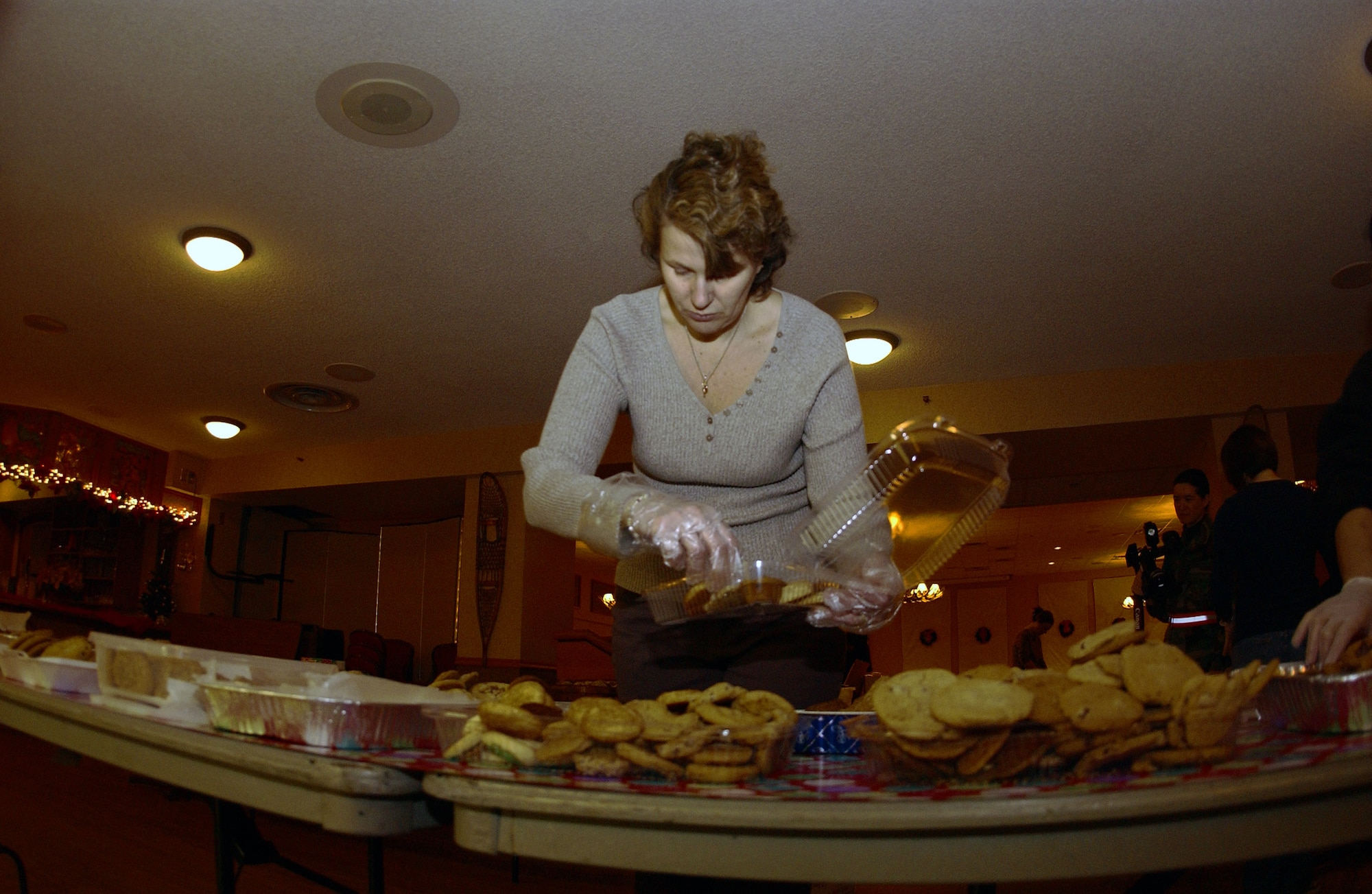 Brenda Lee Restey boxes cookies Dec. 14 at the Yukon Club at Eielson Air Force Base, Alaska. The boxed cookies will be delivered via squadron first sergeants to single Airmen living in Eielson AFB's dormitories. The holiday gesture is part of Operation Cookie Crunch, a yearly event organized and sponsored by the Eielson Officer's Spouses Club. Mrs. Restey is the wife of Col. Michael Restey, who is with the 354th Medical Group and currently deployed to Southwest Asia.  (U.S. Air Force photo/Airman 1st Class Nora Anton) 
