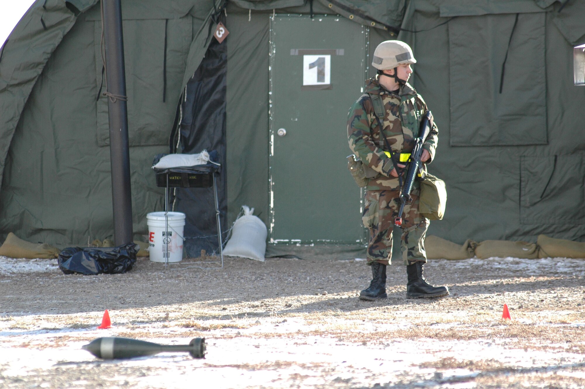 Airman 1st Class Michael Reyes, 341st Civil Engineer Squadron electrician, ensures Airmen remain at a safe distance from unexploded ordnance during an expeditionary readiness exercise at Camp Grizzly Dec. 12. (U.S. Air Force photo/Airman 1st Class Dillon White)