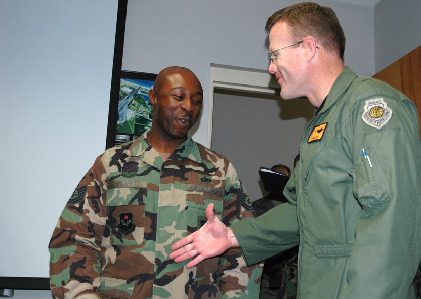 Brig. Gen. Tod Wolters, 325th Fighter Wing commander, congratulates Tech. Sgt. Jamell Jenkins, 325th Security Forces Squadron NCO in charge of installation and physical security, with a Stripes for Exceptional Performers promotion to the rank of master sergeant here Dec. 17.  General Wolters and Chief Master Sgt. Benjamin Van Vleet, 325th Fighter Wing command chief master sergeant presented three individuals with the immediate STEP promotion.  (U.S. Air Force photo/Staff Sgt. Timothy R. Capling)