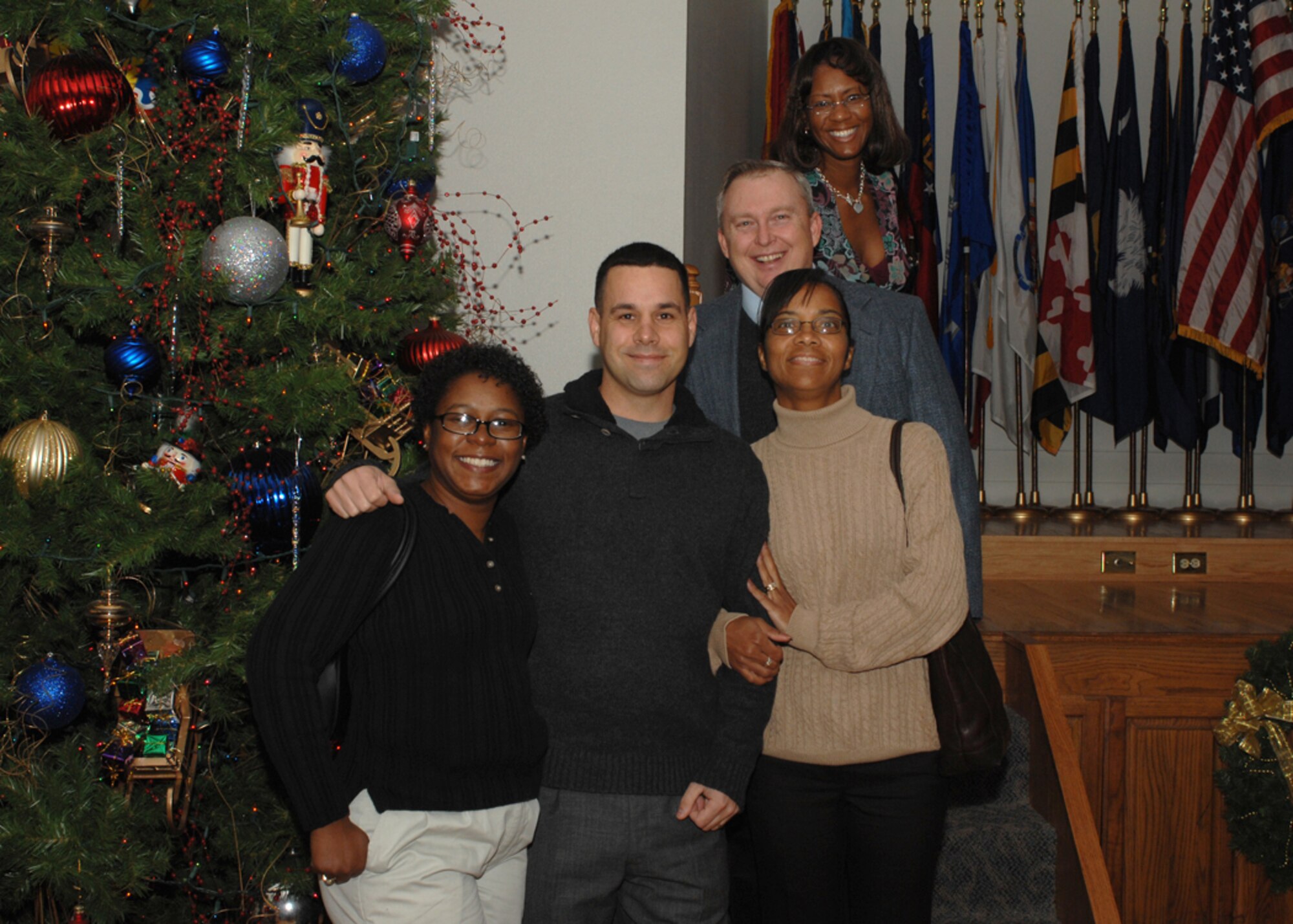Members of Team Dyess pose for a photo beside the Christmas tree at the 7th Bomb Wing holiday party Dec. 9. (U.S. Air Force photo by SrA Courtney Garrard)