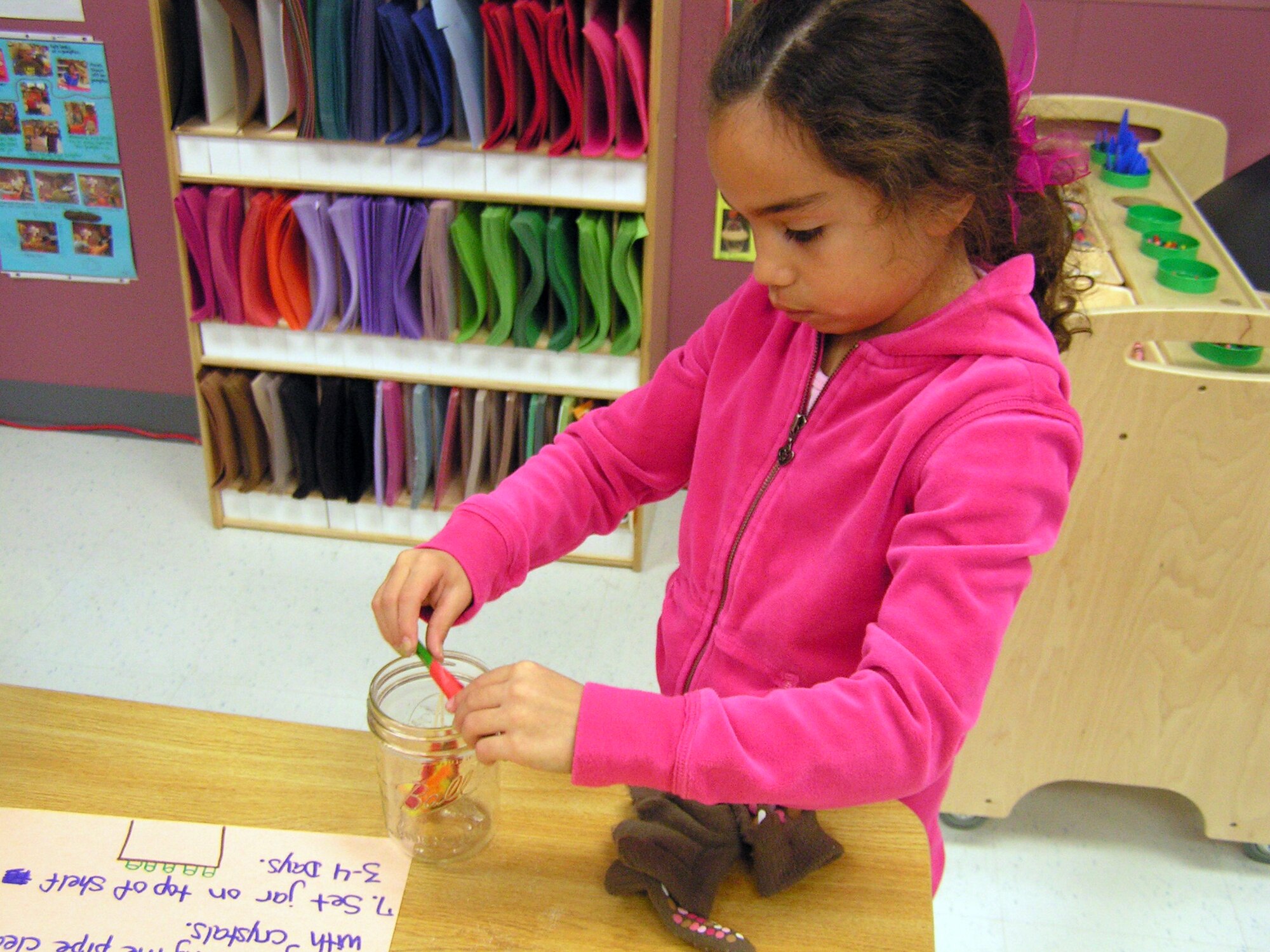 Emma Atherton, Daughter of Diana and Tech. Sgt. Neil Atherton, 509th Maintenance Squadron, makes a crystal ornament in the art area at the School-Age Program. School-Age program assistants plan and provide a wide variety of interesting and fun activities based on children's input. Parents may enroll their child for before school care, after school care, or before and after school care. School-Age program provides full day care on out-of-school days and a full-day summer camp. Fees are based on total family income.