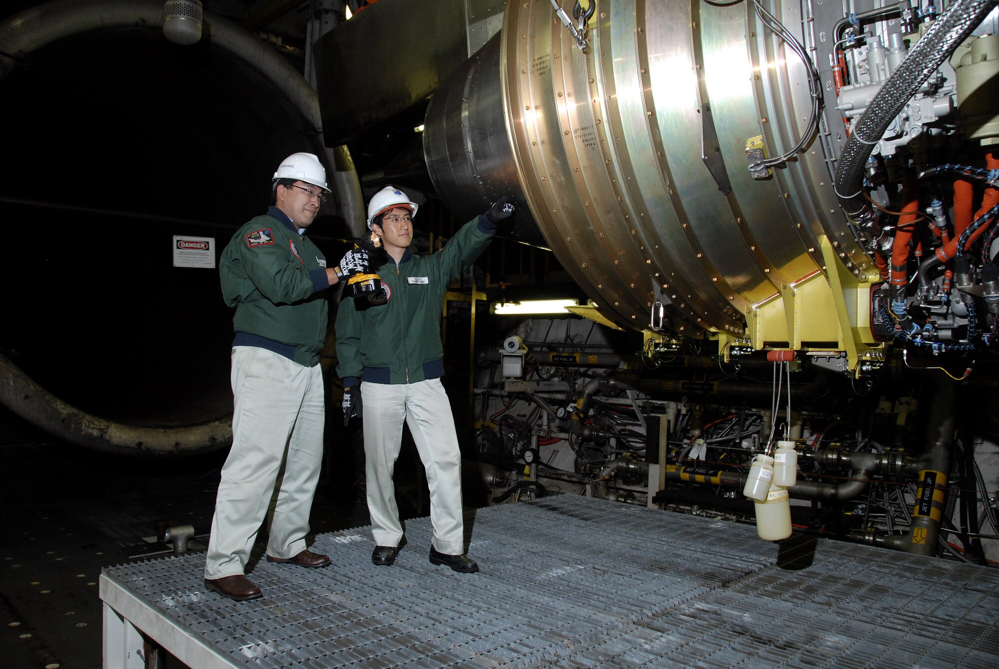 From left, Atsushi Hirano and Yoshiki Miyairi, researchers in Japan’s Technical Research and Development Institute (TRDI) within the Ministry of Defense (MOD) inspected the XP-1 engine during a break in testing at Arnold’s C-2 test cell. (Photo by Rick Goodfriend)