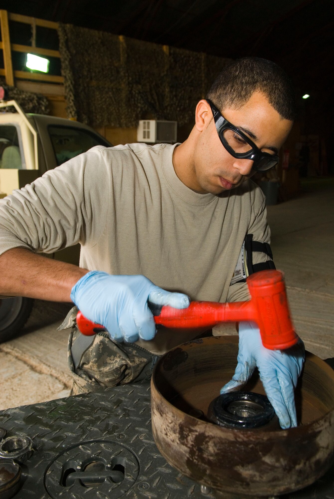 BALAD AIR BASE, Iraq -- Staff Sgt. Elvin Rose, a 332nd Expeditionary Maintenance Squadron munitions equipment maintainer, secures a bearing seal onto the brake drum of a munitions trailer here, Dec. 19. The trailer is being disassembled as part of a 720-day inspection to see if there are any problems that could make it inoperable. Sergeant Rose is deployed from Spangdahlem Air Base, Germany. (U.S. Air Force photo/Staff Sgt. Joshua Garcia)