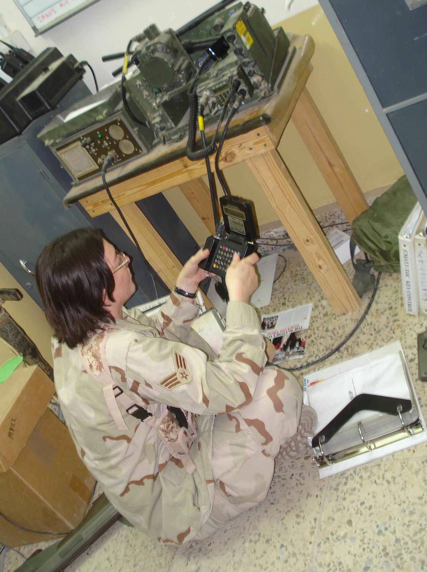 Senior Airman Jennifer Noyes, 1st Air and Space Communications Squadron, prepares tactical radios for convoys, during her 365-day deployment to Baghdad. Airman Noyes was awarded the Defense Meritorious Service Medal for her accomplishments during the deployment. (Courtesy photo)
