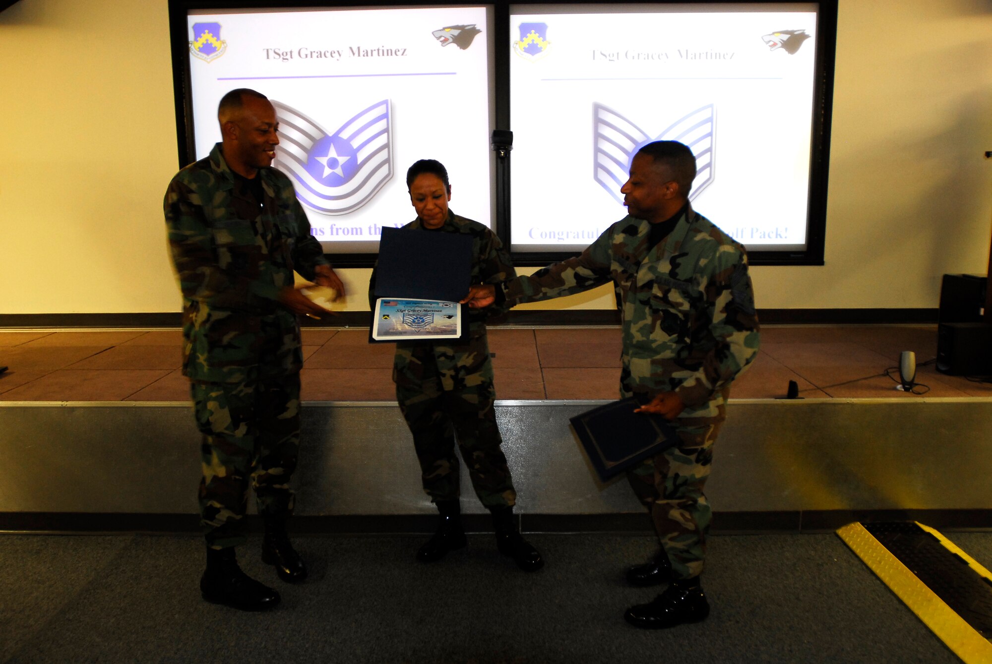 KUNSAN AIR BASE, South Korea -- Staff Sgt. Gracey Martinez, Airfield Management Non-Commissioned Officer In-Charge, is STEP promoted to Technical Sergeant here Dec 20.  Sgt. Martinez is presented her new rank by Colonel CQ “Wolf” Brown, 8th Fighter Wing Commander, and Chief Master Sgt. Anthony “Wolf Chief” Brinkley, 8th Fighter Wing Command Chief, during wing stand-up.  (U.S. Air Force photo/ Tech. Sgt. Quinton T. Burris)