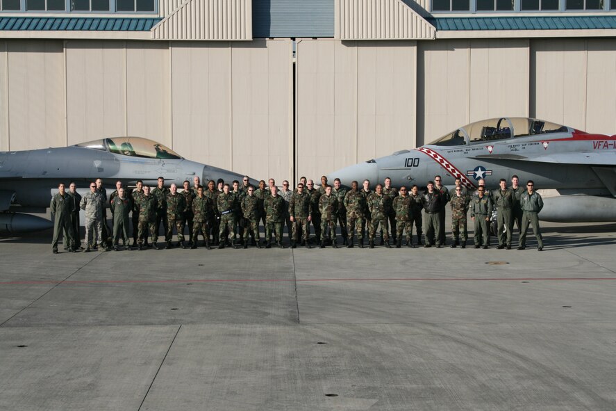 ATSUGI NAVAL AIR FACILITY, Japan -- Airmen from the 8th Fighter Wing and Sailors from Carrier Air Wing FIVE (CVW-5) poise for a group photo at the conclusion of the two units training together at the Navy base in Japan. Forty Airmen from Kusan went to Atsugi for combat air training. (Courtesy photo)
