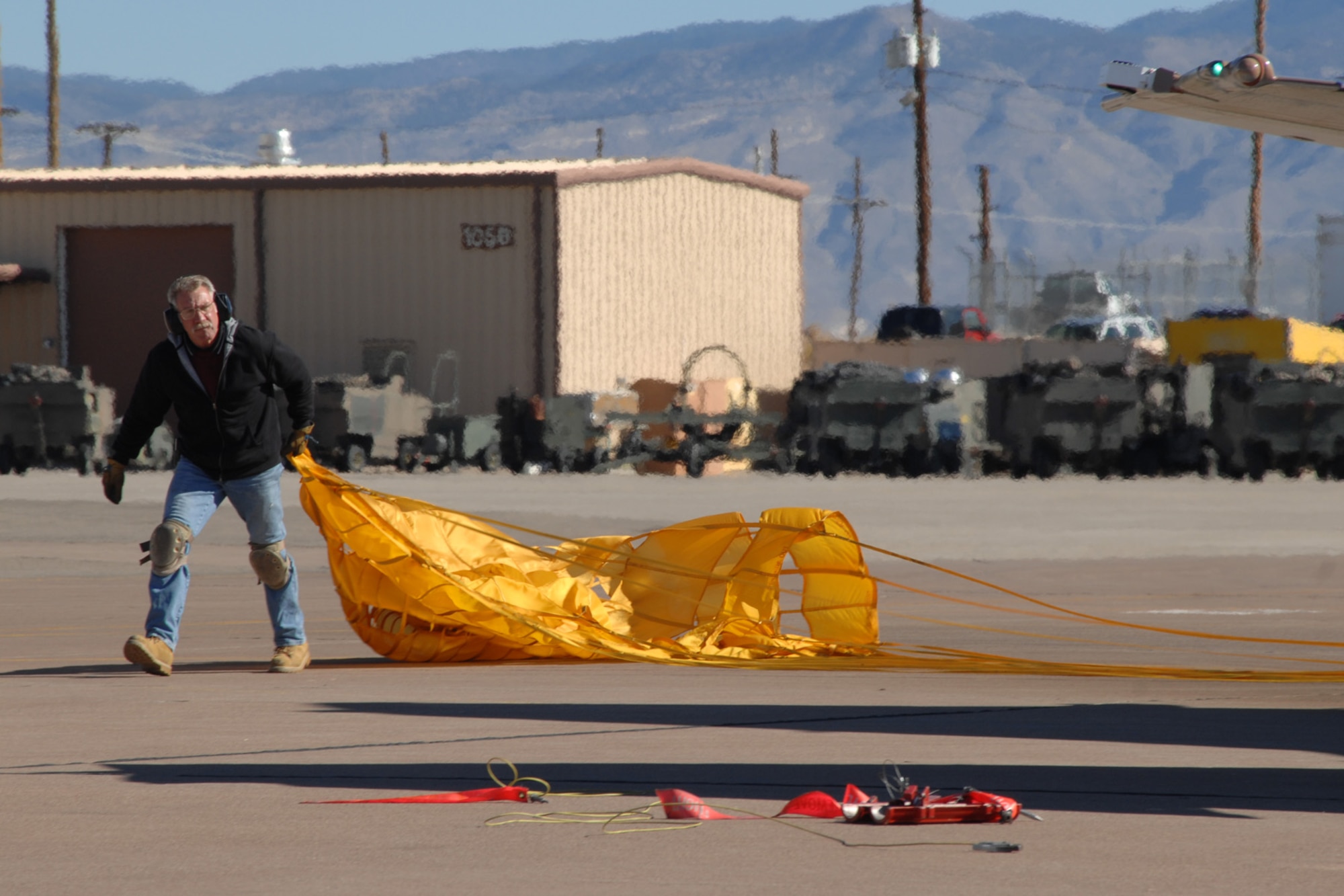 Art Fisher, Lockheed Martin Services Incorporated, retrieves the parachute of a F-4 Phantom Dec. 20, 2007, at Holloman Air Force Base, N.M. The Phantom was flown by Brig. Gen. David Goldfein, 49th Fighter Wing commander, and Fisher was one of the maintainers for General Goldfein's first flight in the aircraft. (U.S. Air Force photo/Airman 1st Class Jamal D. Sutter)
