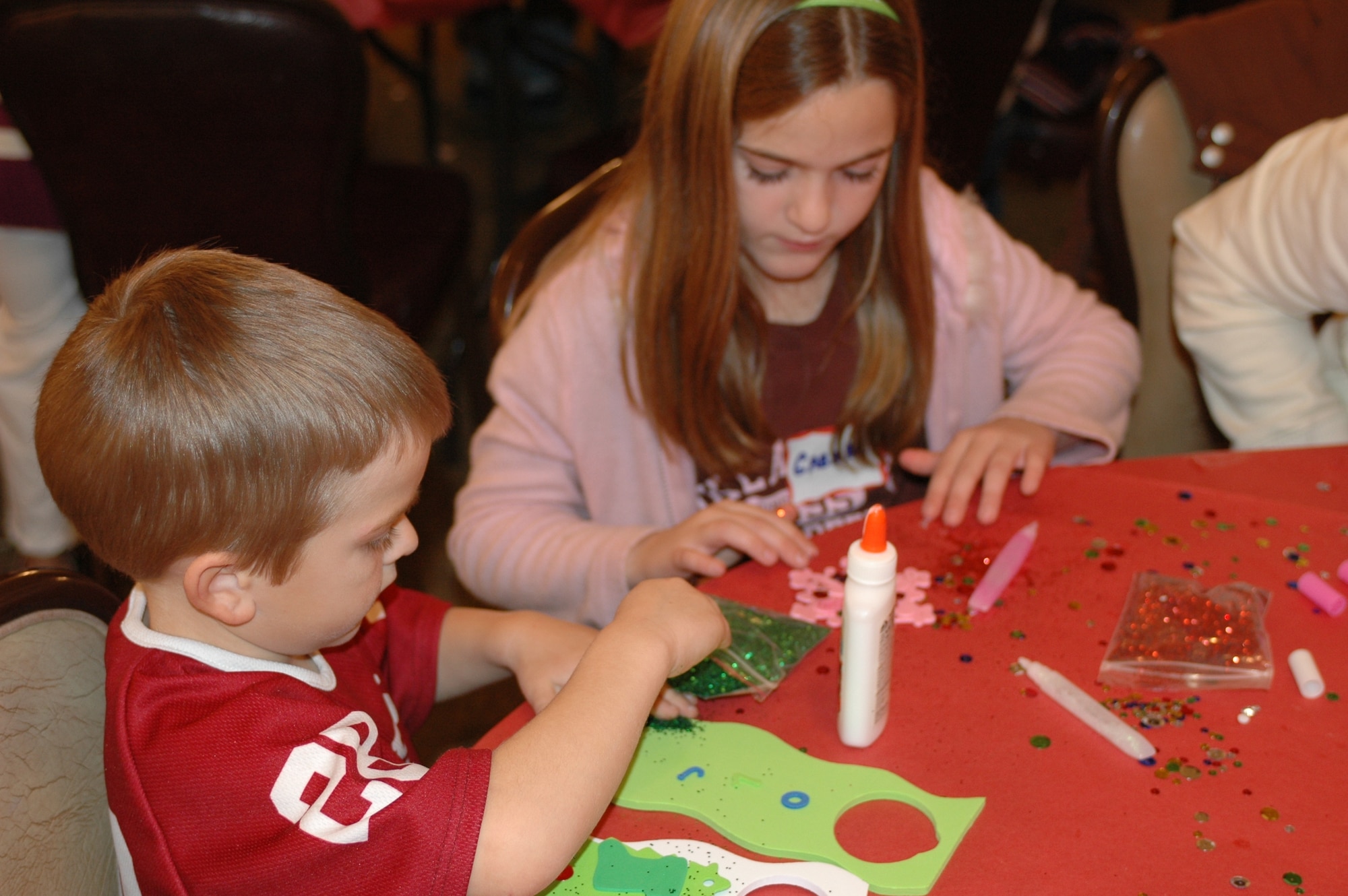 Children work on arts and crafts during the Deployed Spouses Dinner Dec. 18 at the Travis Conference Center. The event gives the spouses and children of those deployed a chance to socialize with other families, hear from base leadership and learn how the military community can assist them while their spouse is deployed. (U.S. Air Force photo/Senior Airman Shaun Emery)