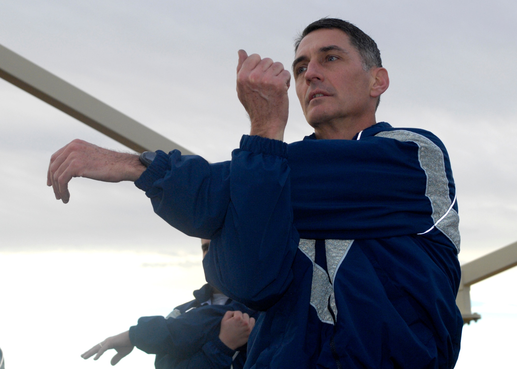 Chief Master Sgt. Jonathan Hake, command chief of Air Force Materiel Command, stretches during Edwards' senior noncommissioned officers group physical training session at the Rosburg Fitness Center here Dec. 18. (Photo by Jeffrey Youngblood)